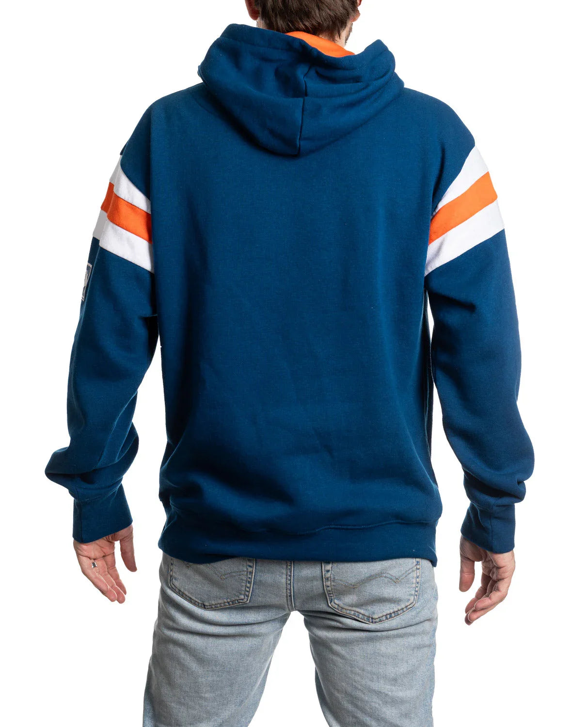 Man wearing blue hoodie with orange and white sleeve stripes, light denim jeans, back view