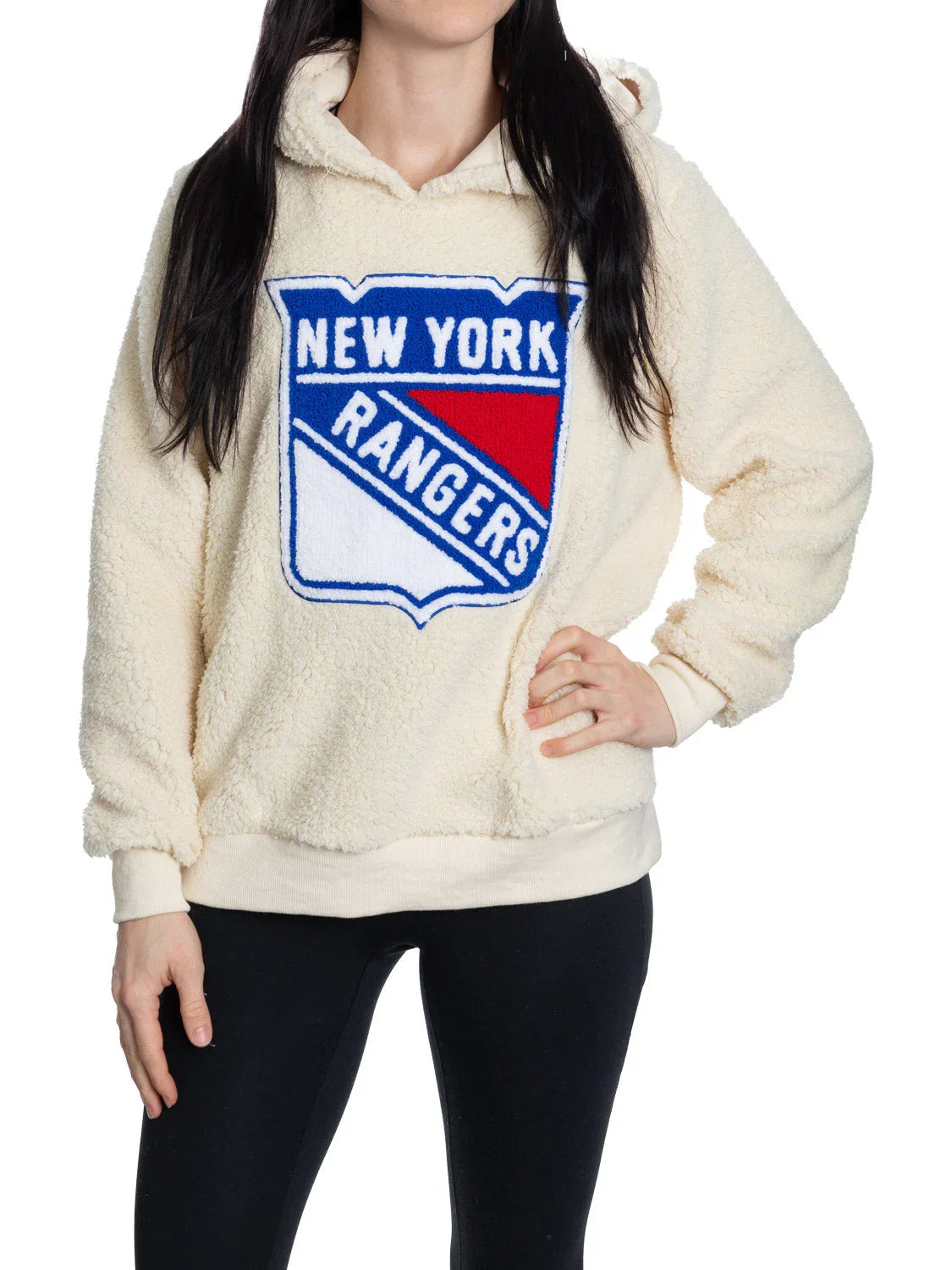 Woman wearing cream sherpa hoodie with New York Rangers logo on front