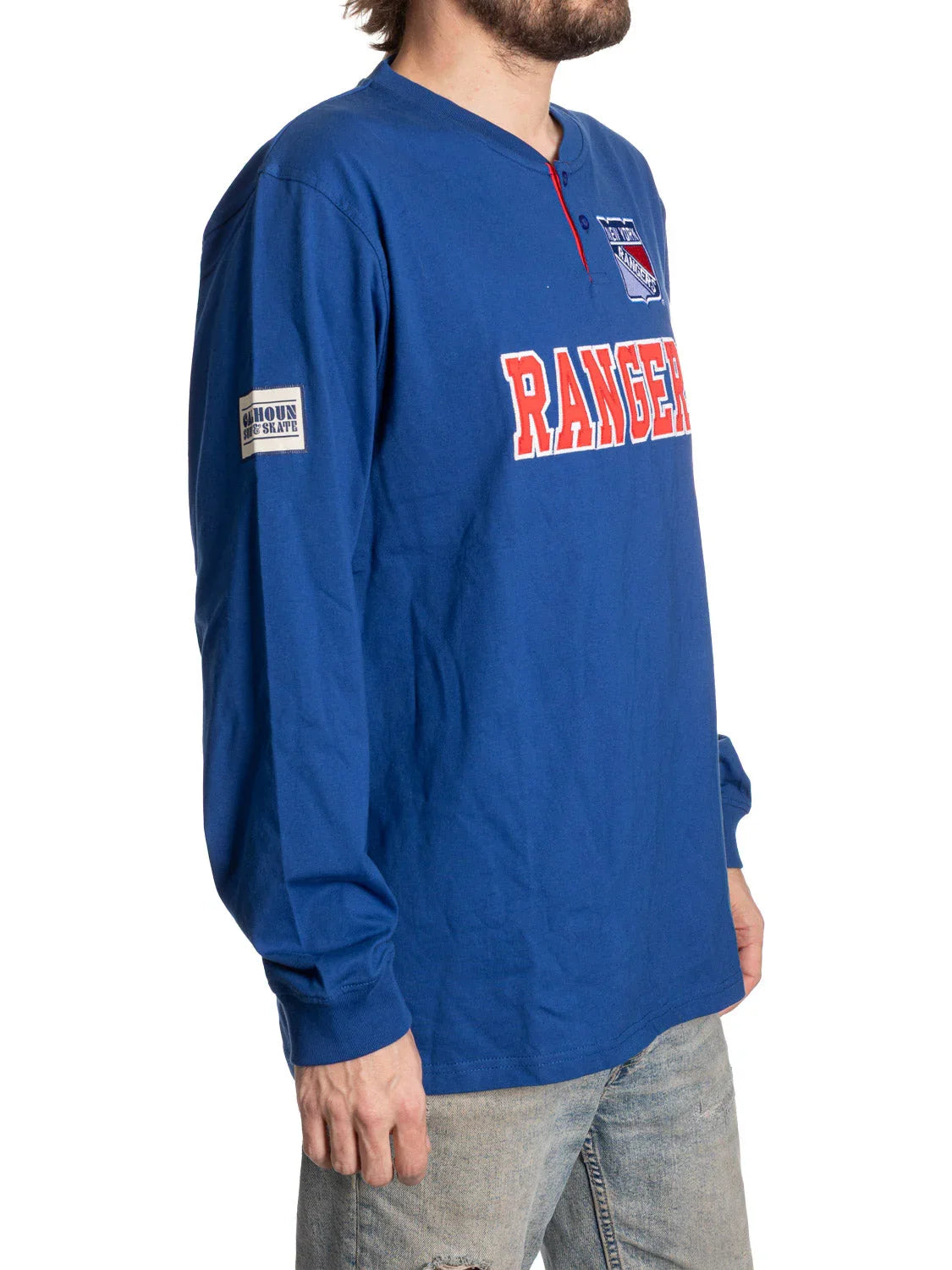 Man wearing blue New York Rangers long sleeve henley shirt with logo and jeans