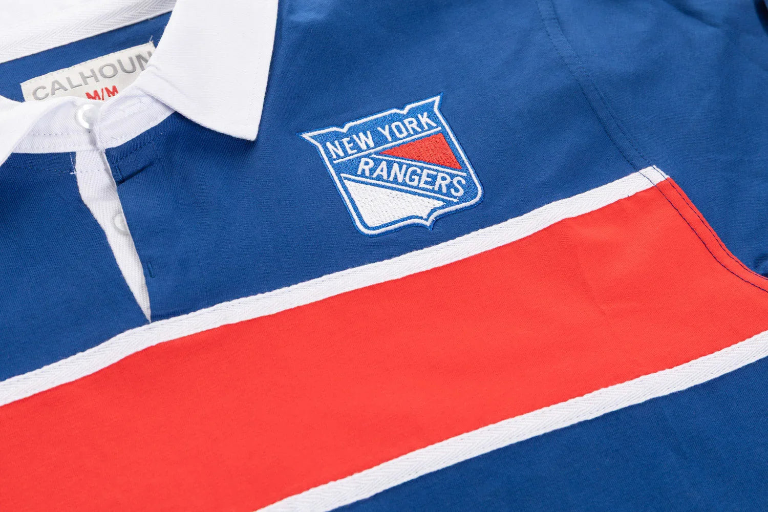 New York Rangers rugby polo shirt with blue, white, and red stripes and embroidered logo