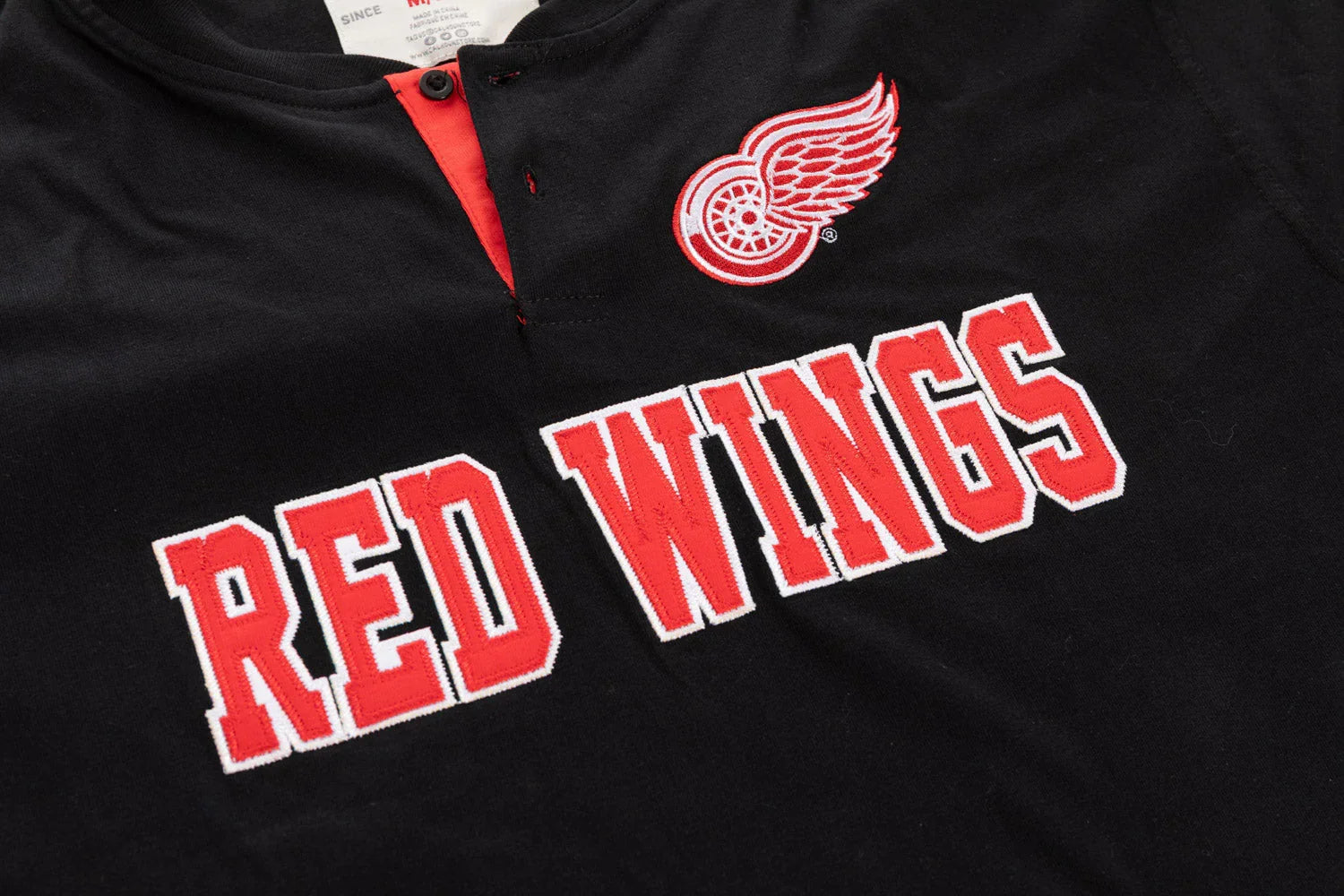 Black Red Wings Henley shirt with red logo and bold embroidered team name