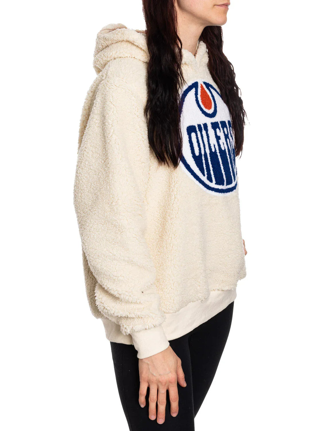 Woman wearing cream Edmonton Oilers sherpa hoodie with team logo, side profile