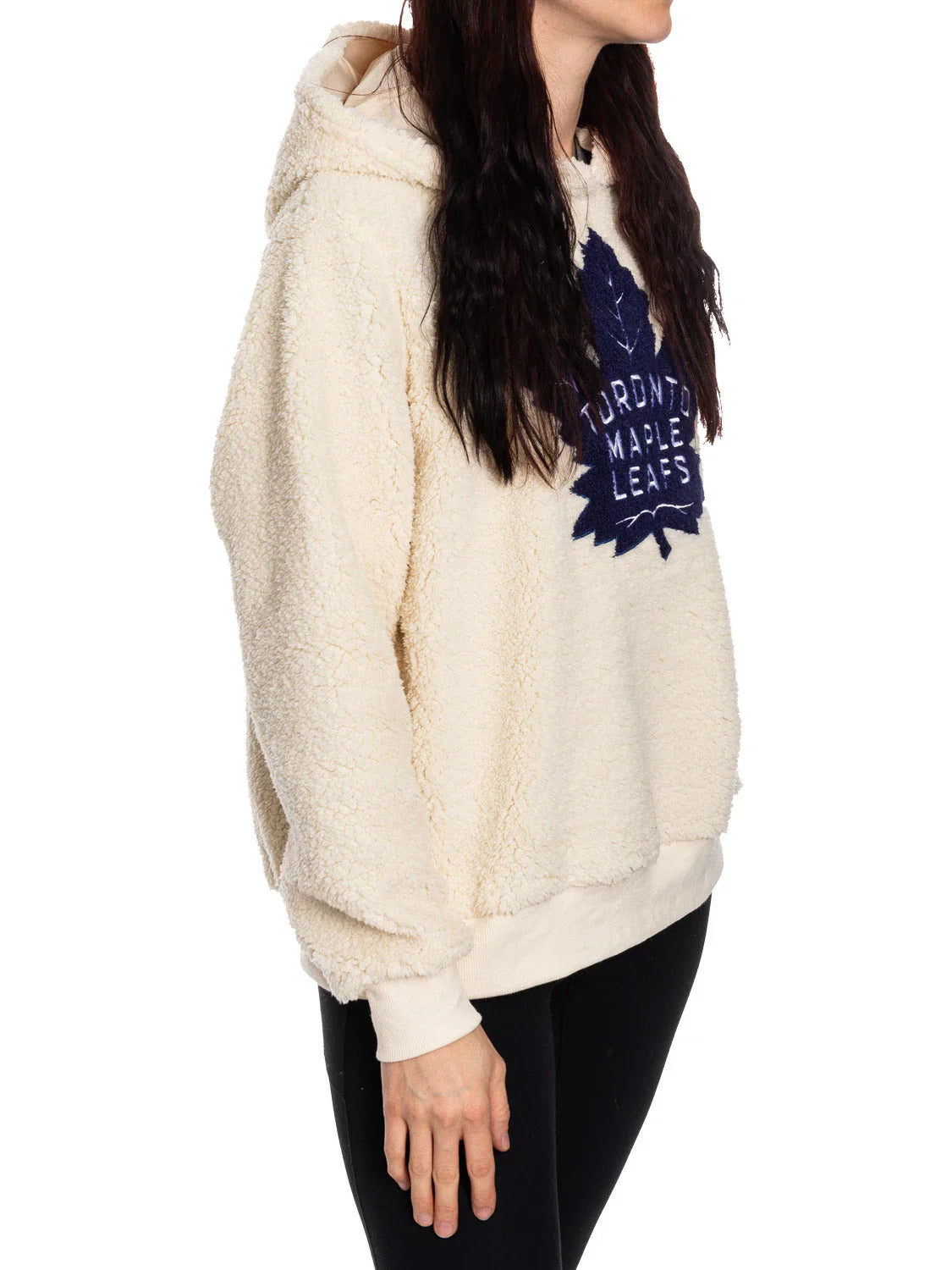 Woman wearing cream Toronto Maple Leafs sherpa hoodie with logo, side view