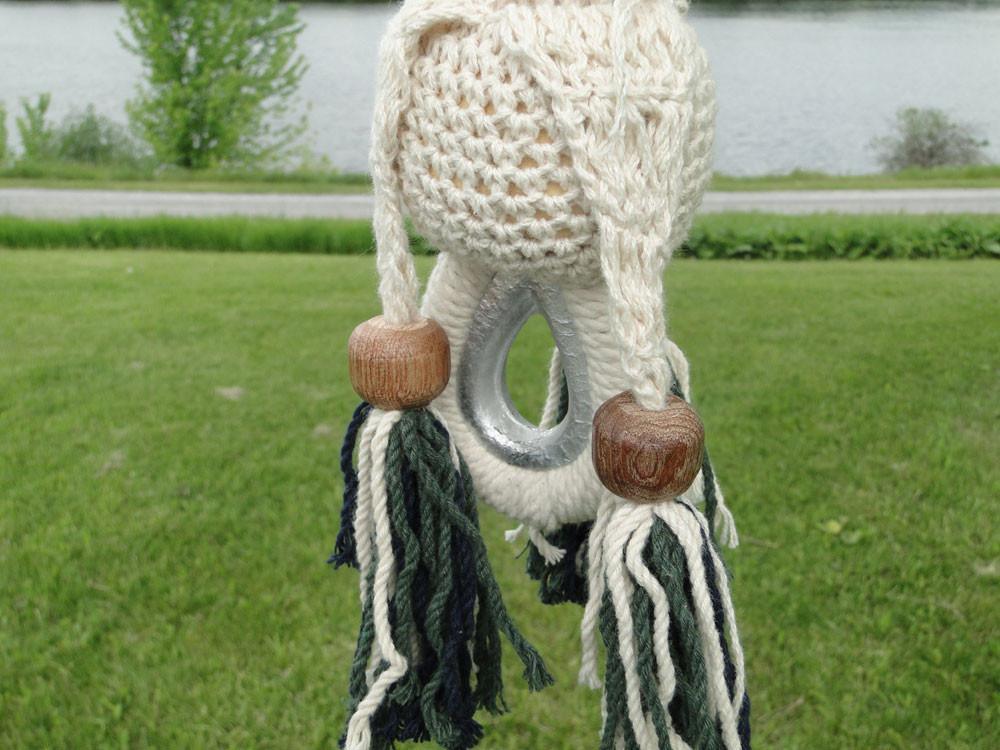 Close-up of Nicaraguan hammock loop with rope, wood beads, and outdoor grass background