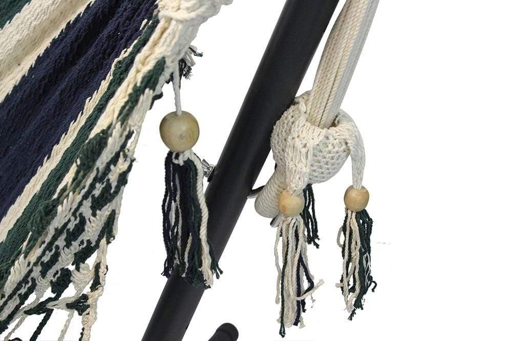 Close-up of Nicaraguan hammock with green, navy, cream stripes on a black metal stand