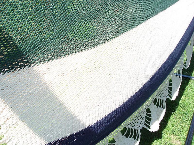 Nicaraguan deluxe hammock with stand, green and white crochet on grass
