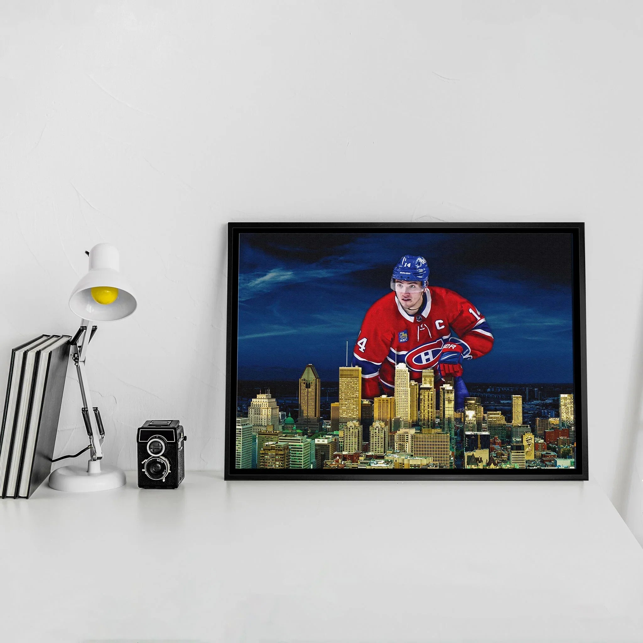 Framed print of Montreal Canadiens hockey player over city skyline on modern white desk