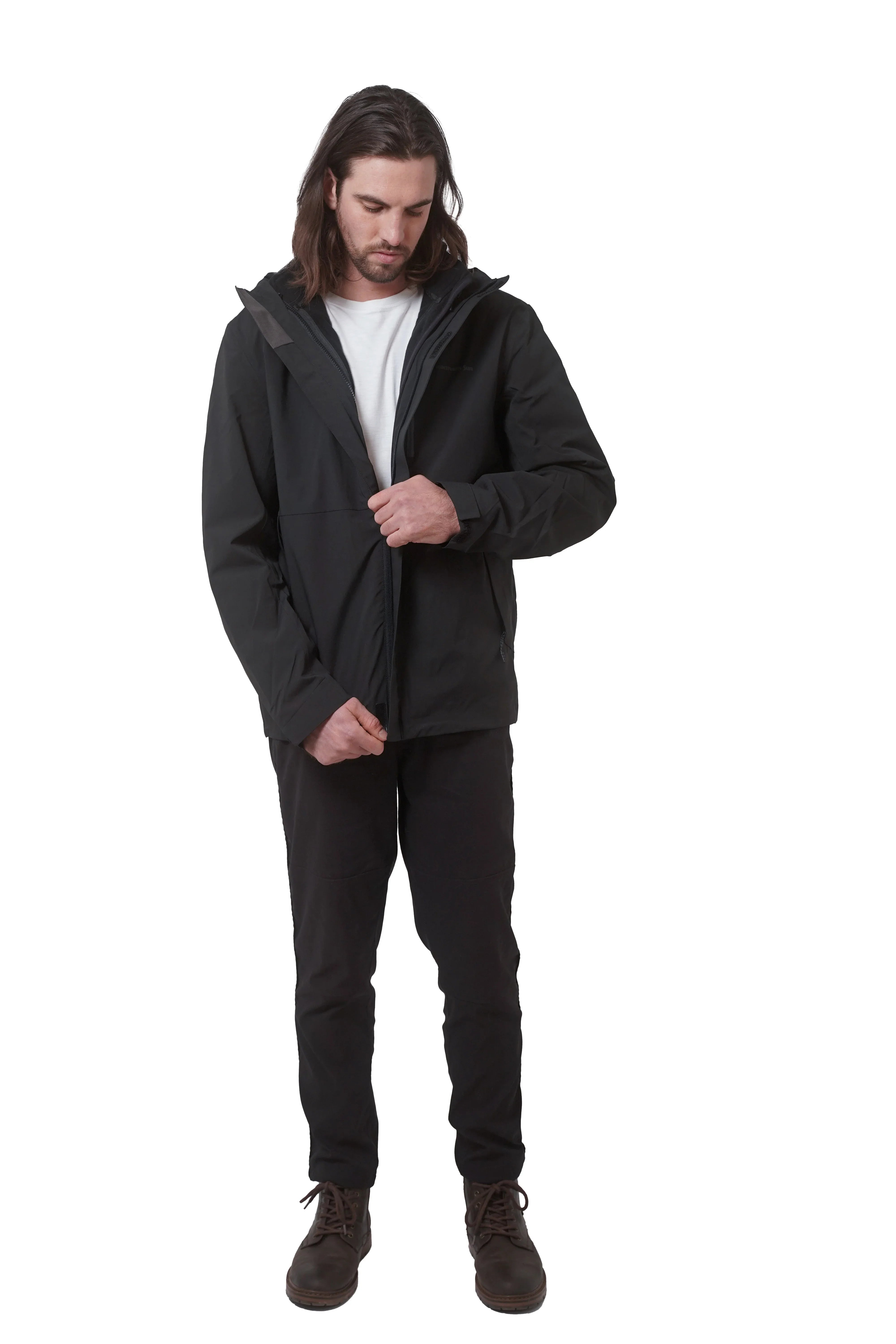 Man wearing open black 3-in-1 jacket and boots on white background