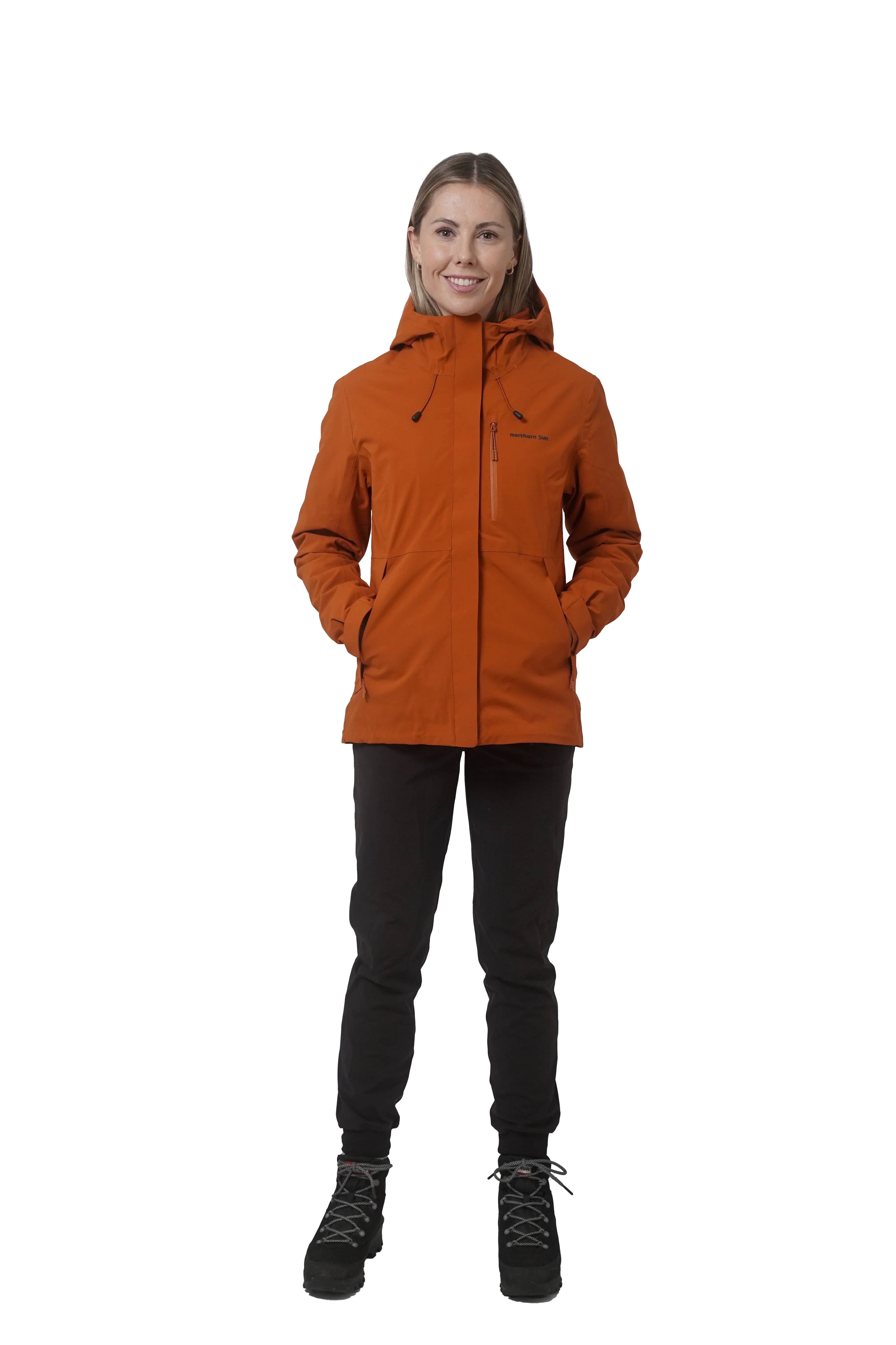 Woman wearing orange Northern Sun women's 3-in-1 jacket, black pants, and boots