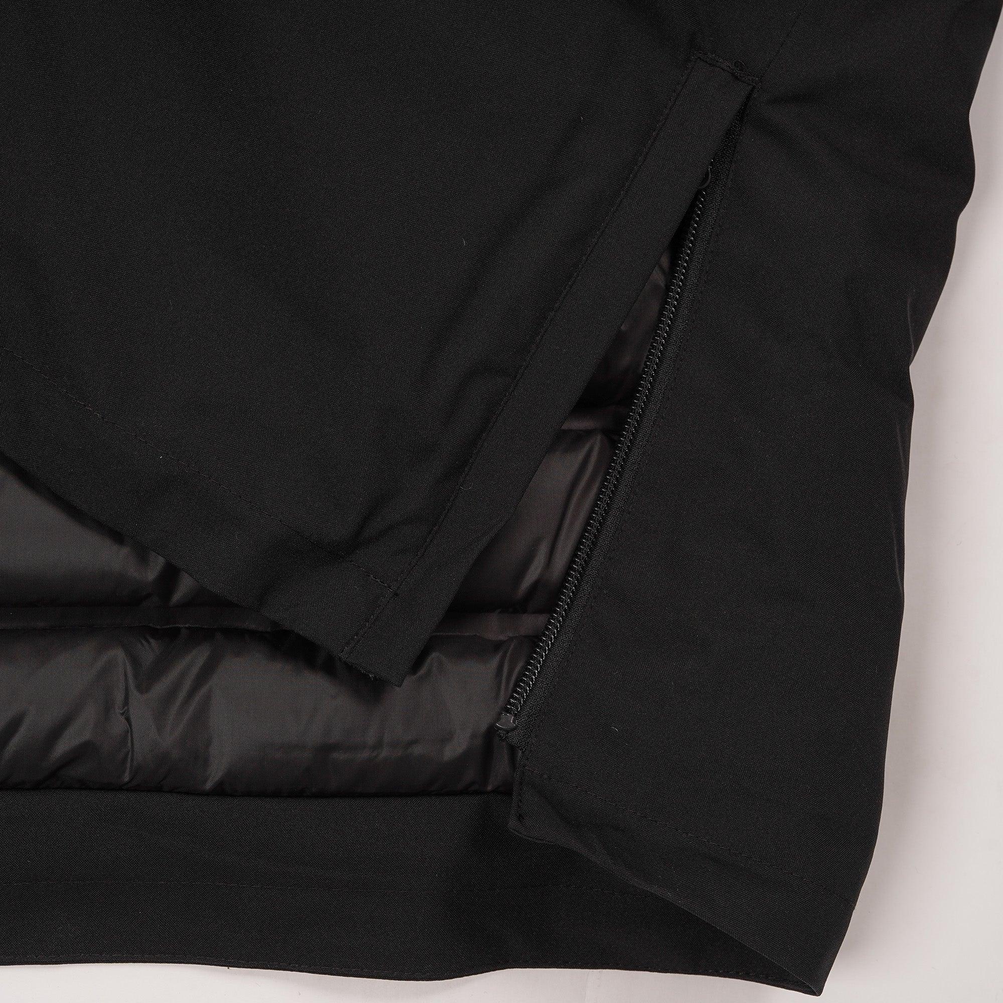 Close-up of black insulated jacket with visible zipper and padded lining