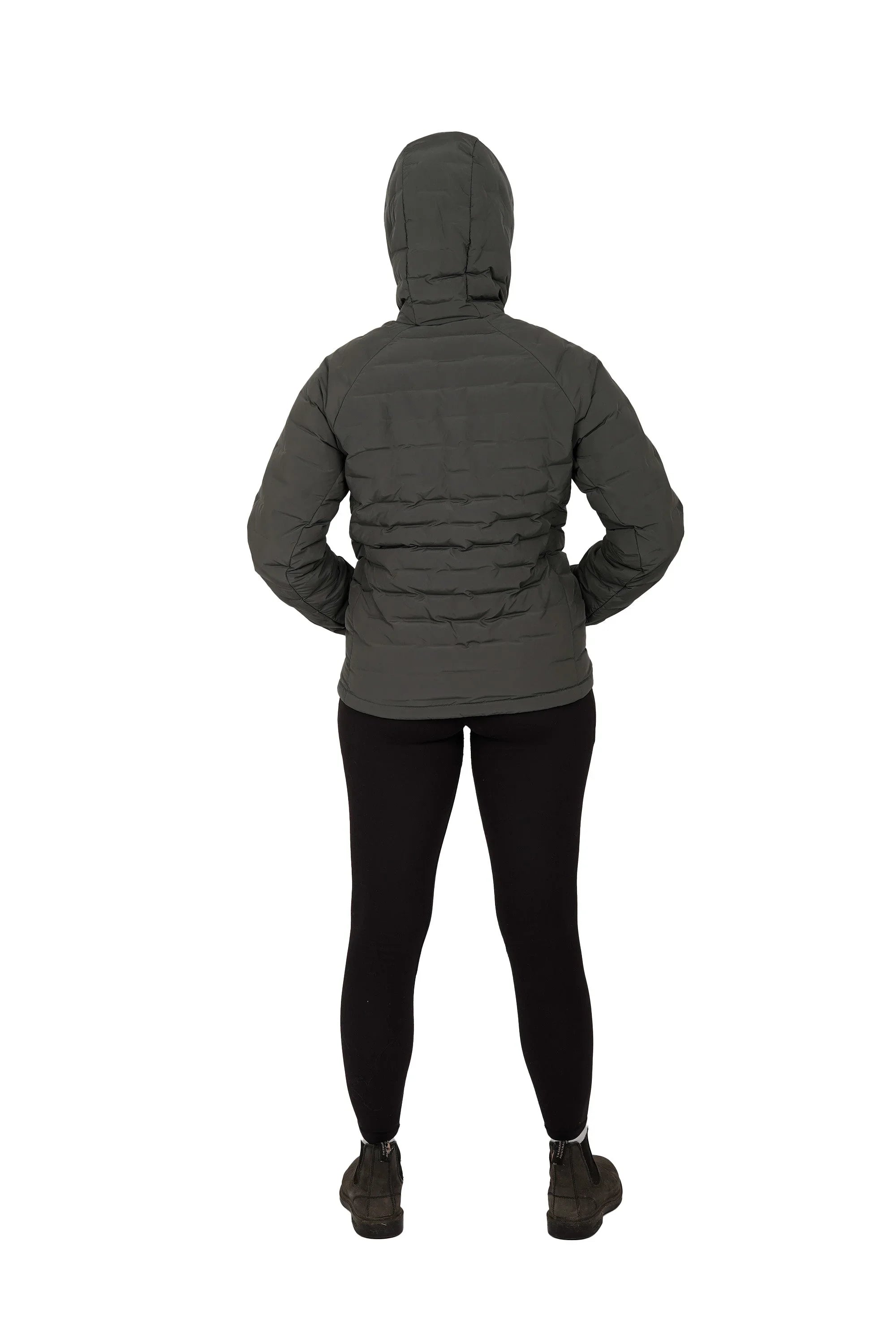 Back view of woman wearing black lightweight down jacket with hood up and black leggings
