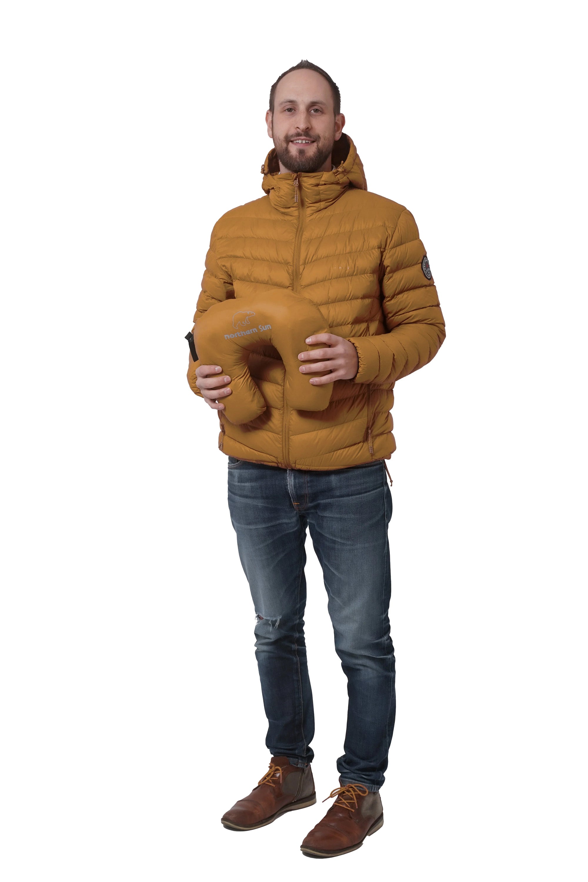 Man wearing mustard Northern Sun lightweight packable down jacket holding matching pouch