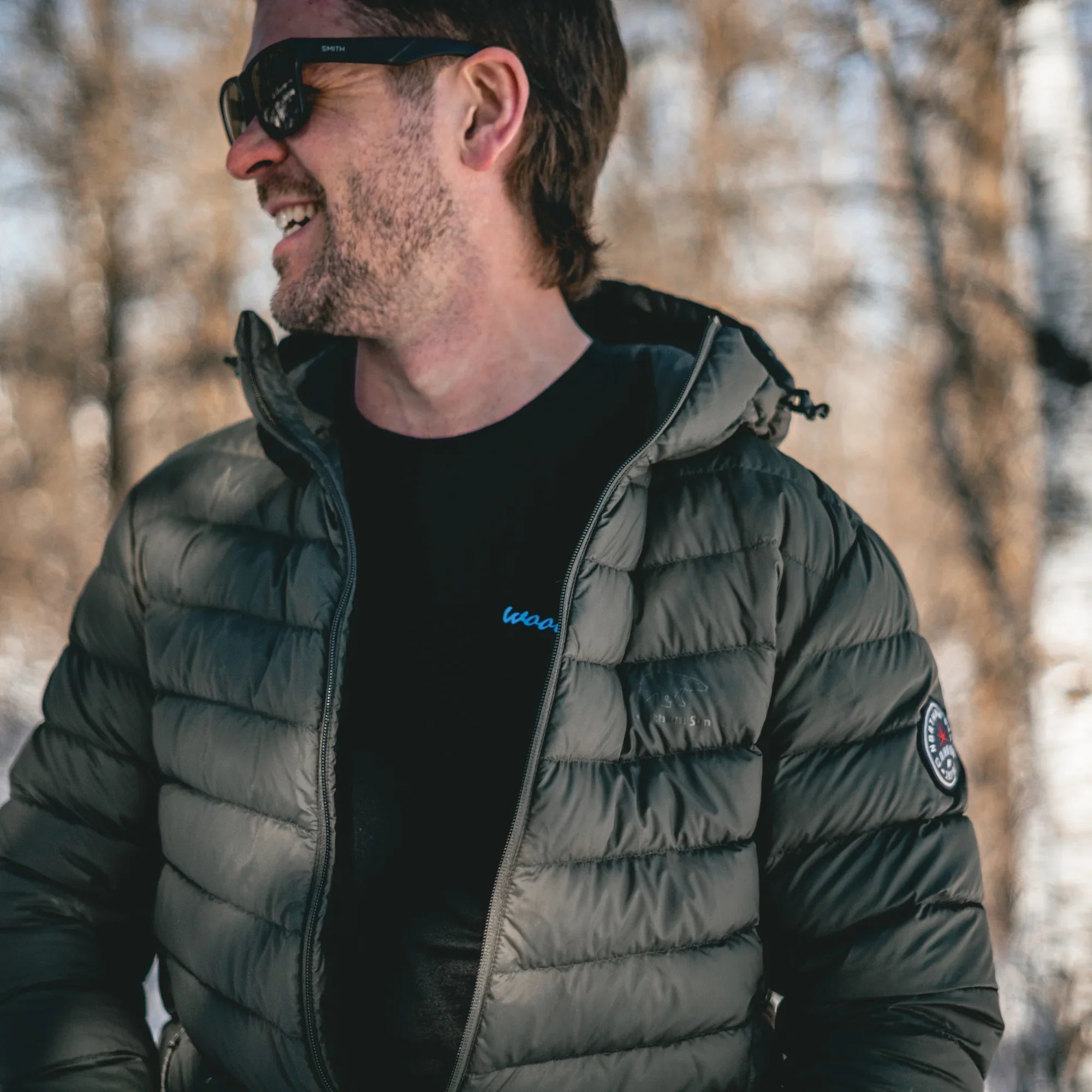 Man wearing lightweight packable down puffer jacket outdoors in winter