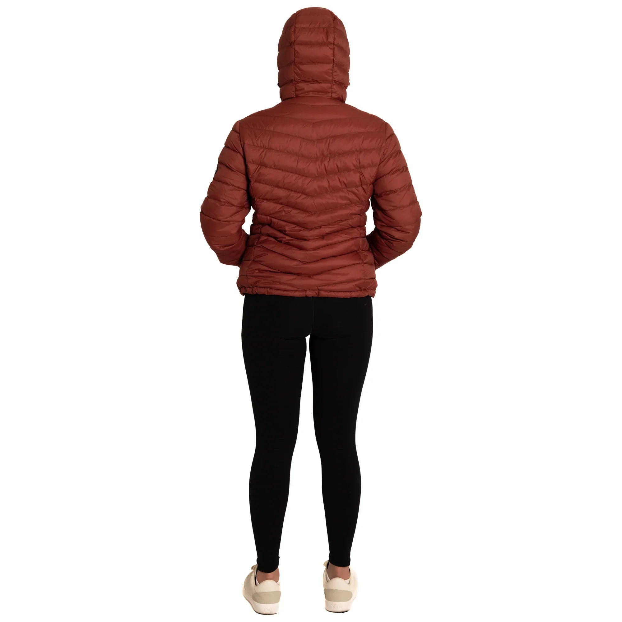 Woman in hooded brown puffer jacket, black leggings, and white sneakers, rear view