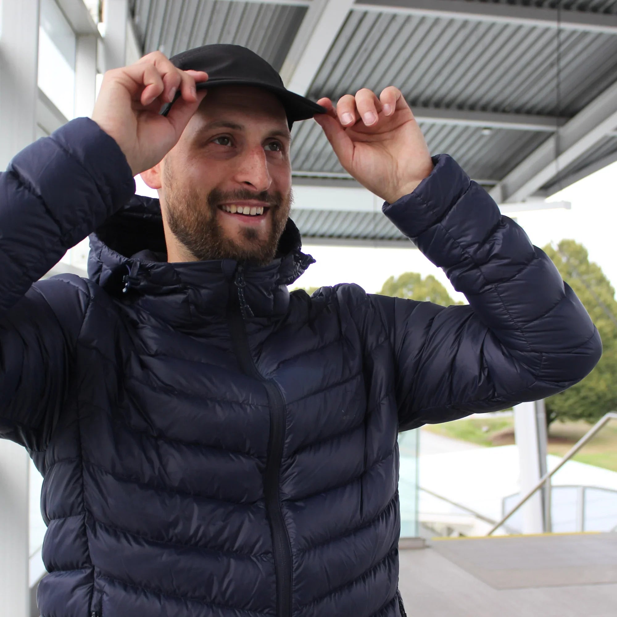 Man wearing navy packable down jacket for commuting outdoors in Canada