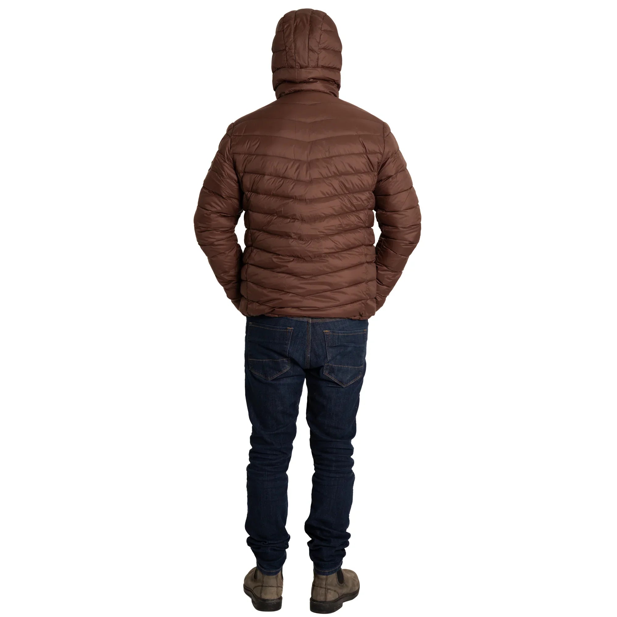 Man in brown puffer jacket with hood, dark jeans, and boots, standing on white background