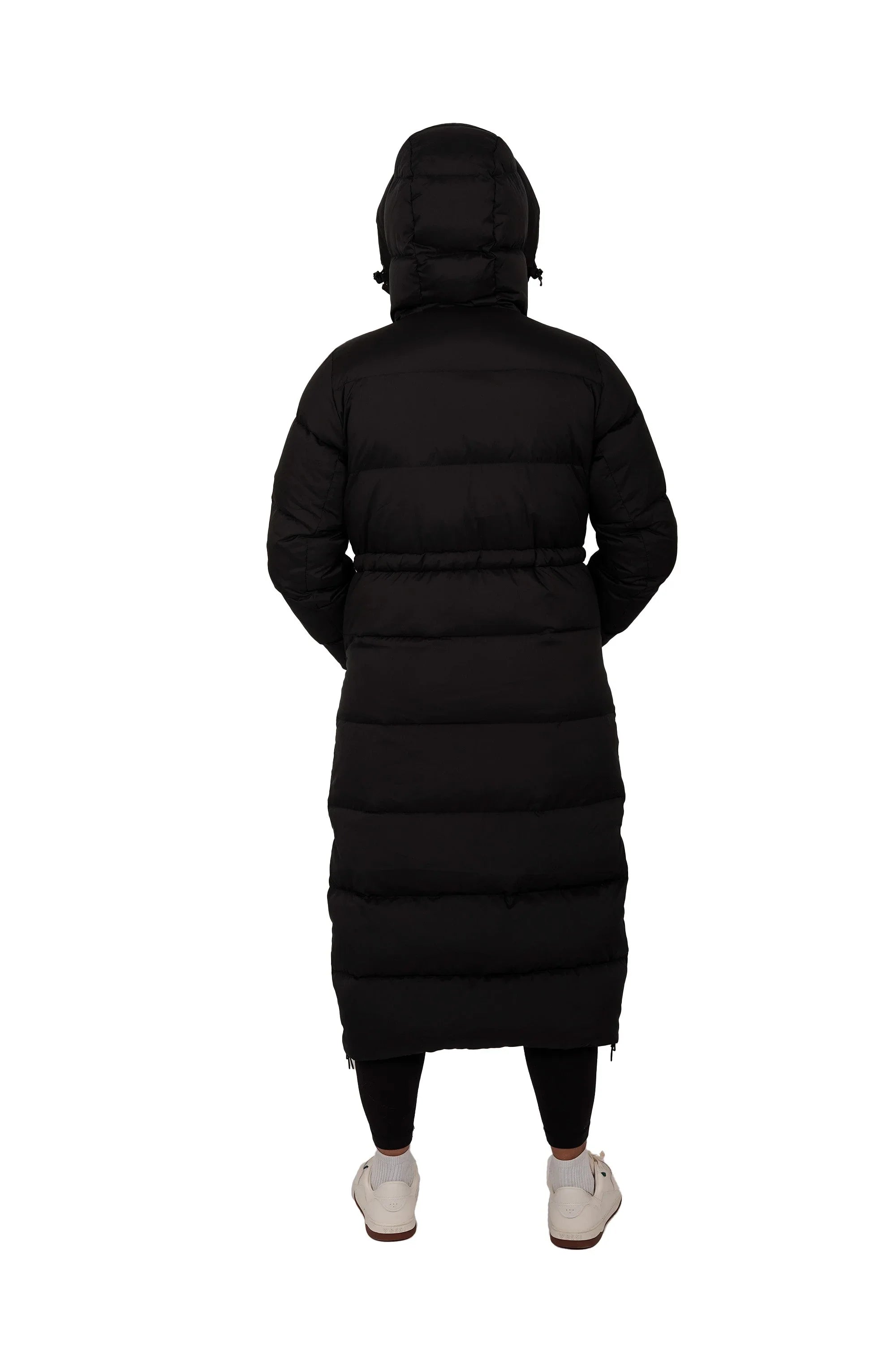 Back view of long black puffer coat with hood, worn by person on white background