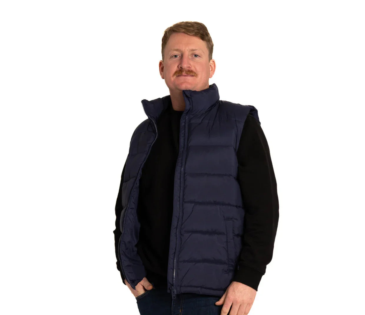Man wearing navy puffer vest and black shirt, front view, white background