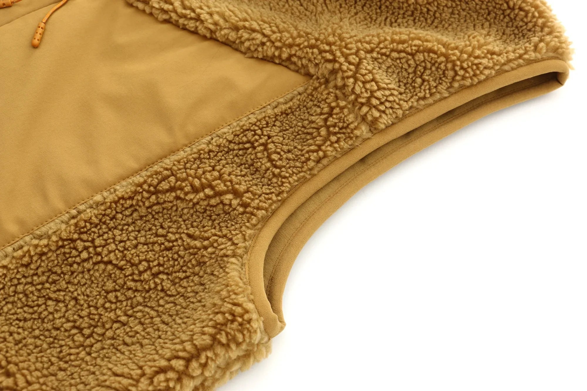 Close-up of tan unisex sherpa vest arm cuff with soft fleece texture detail