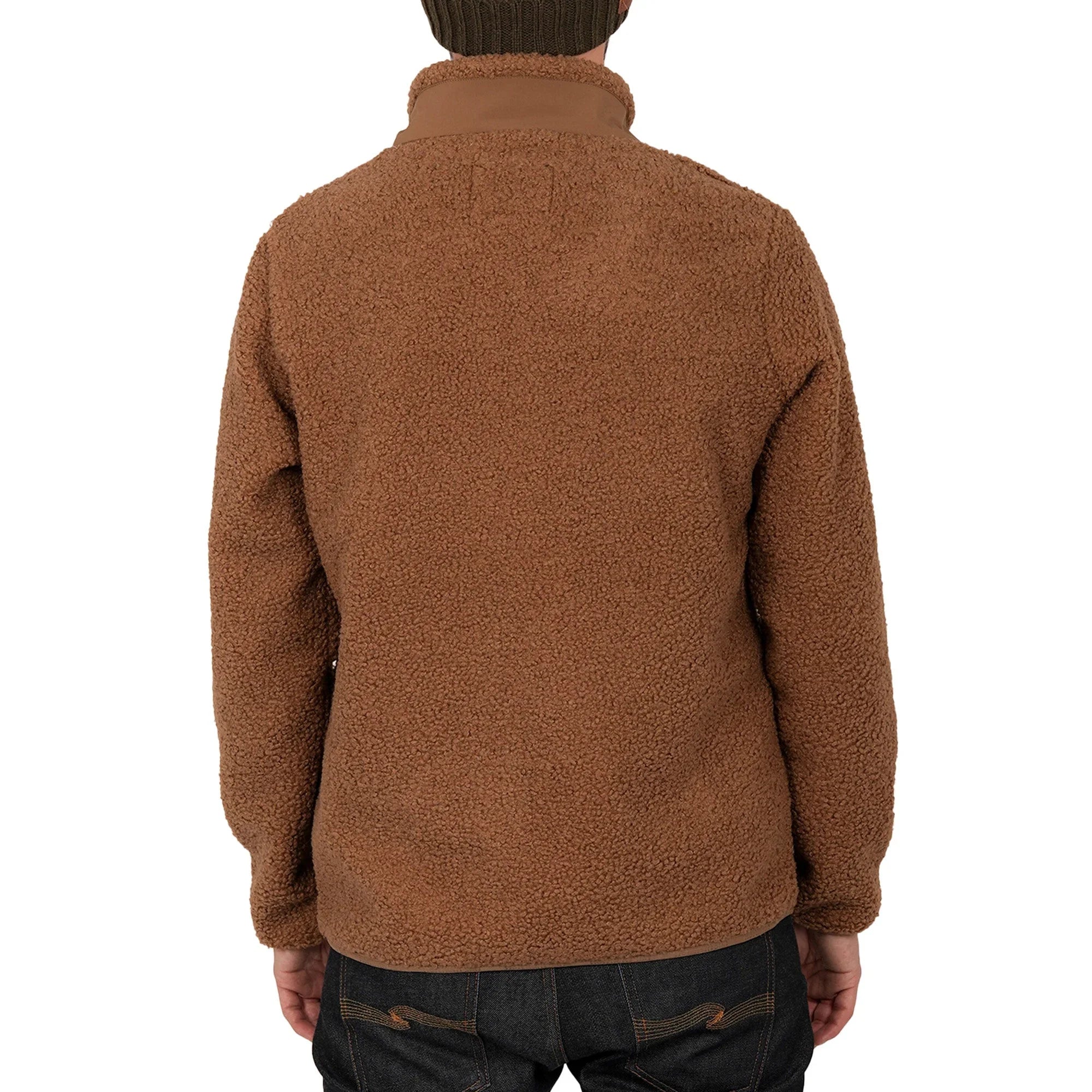 Back view of man wearing brown teddy fleece jacket and dark jeans