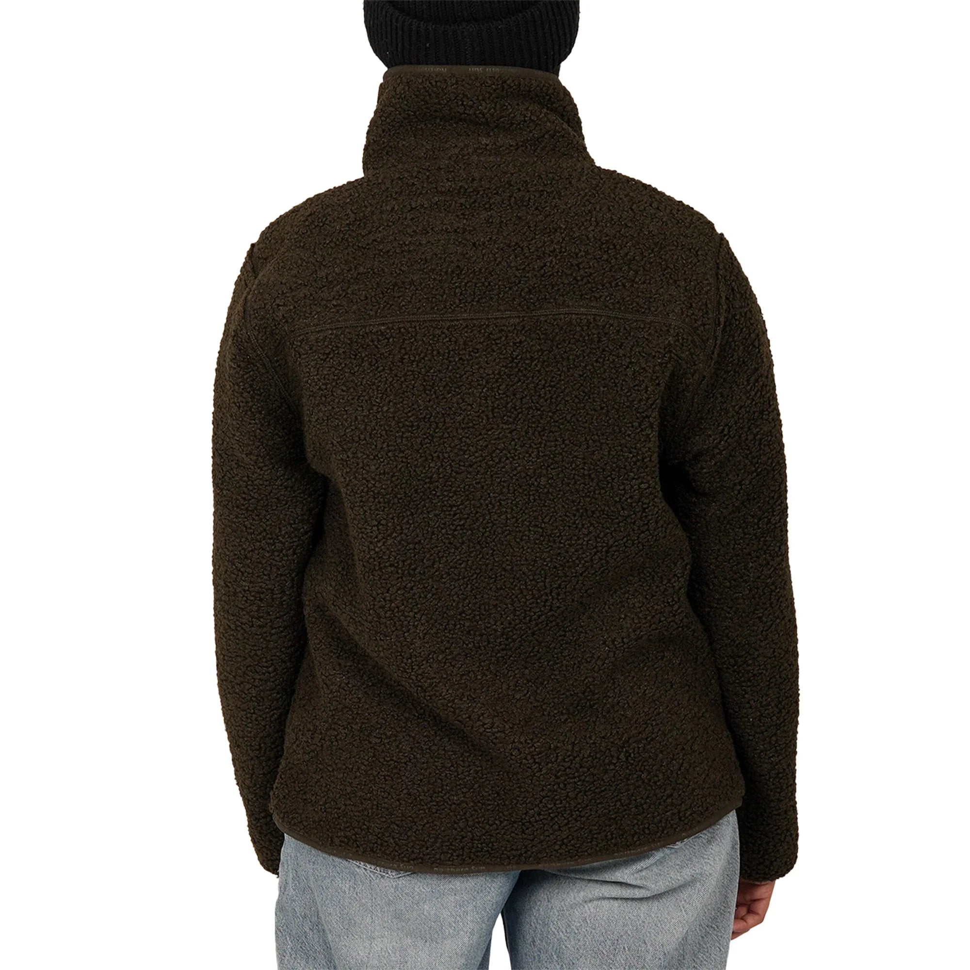 Back view of woman wearing green teddy fleece jacket and blue jeans