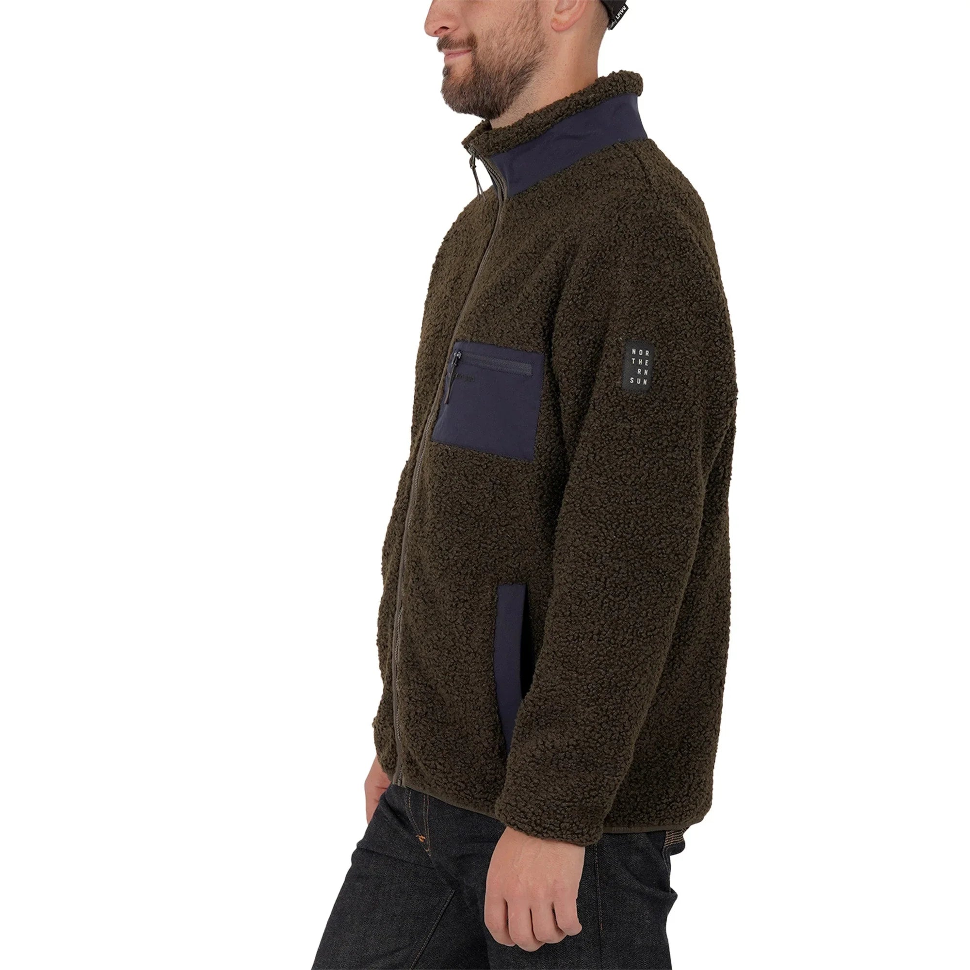 Man wearing brown teddy fleece jacket with navy zipper pockets, side view