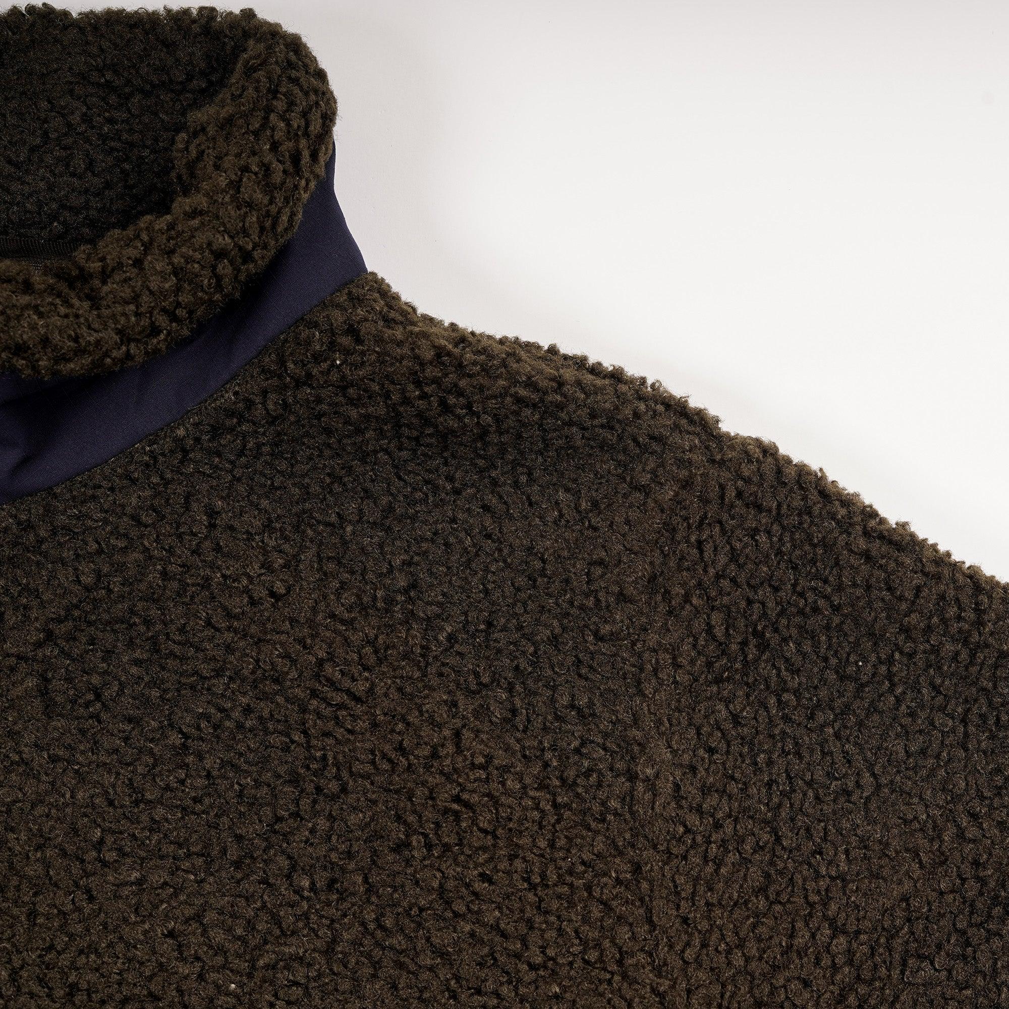Men's brown teddy fleece jacket with high collar, close-up on textured fabric