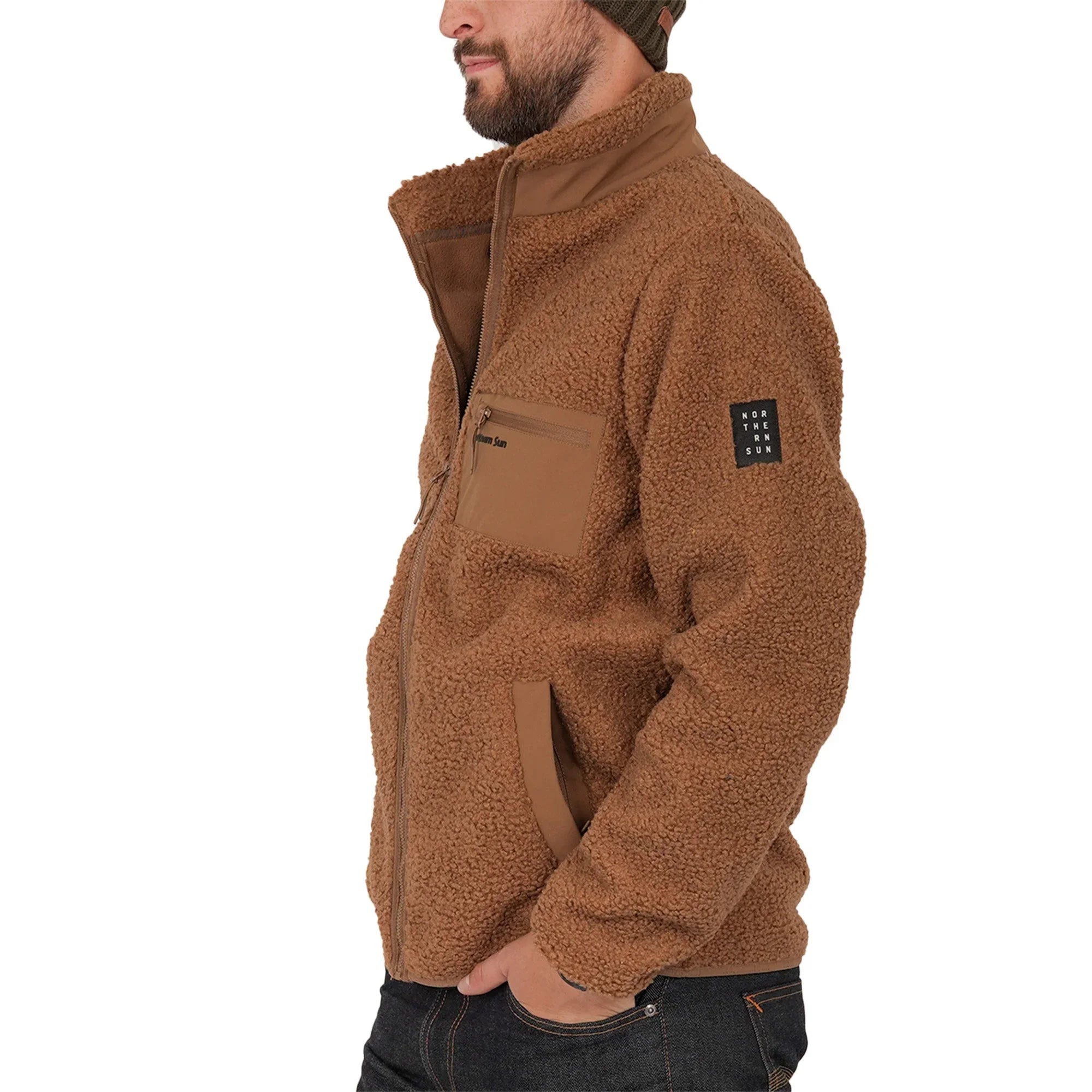 Man in brown teddy fleece jacket with Northern Sun logo patch on sleeve, side view