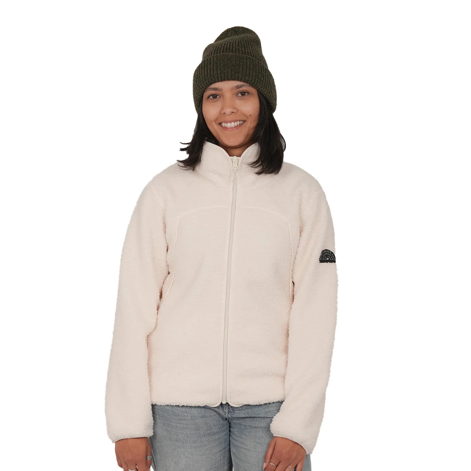 Smiling woman in cream teddy fleece jacket and green beanie, front view, white background