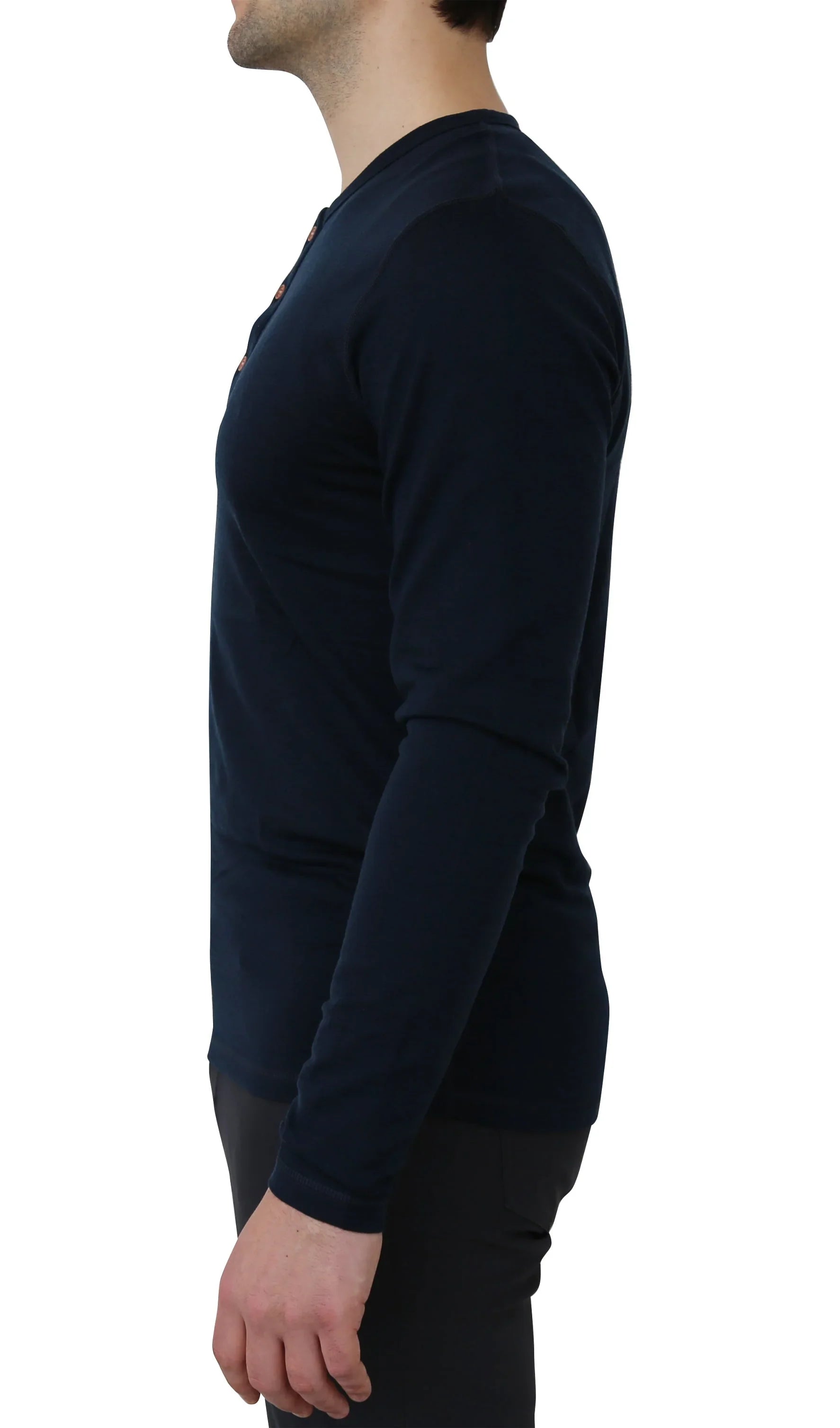 Man wearing navy merino wool long sleeve Henley shirt, side view, plain background