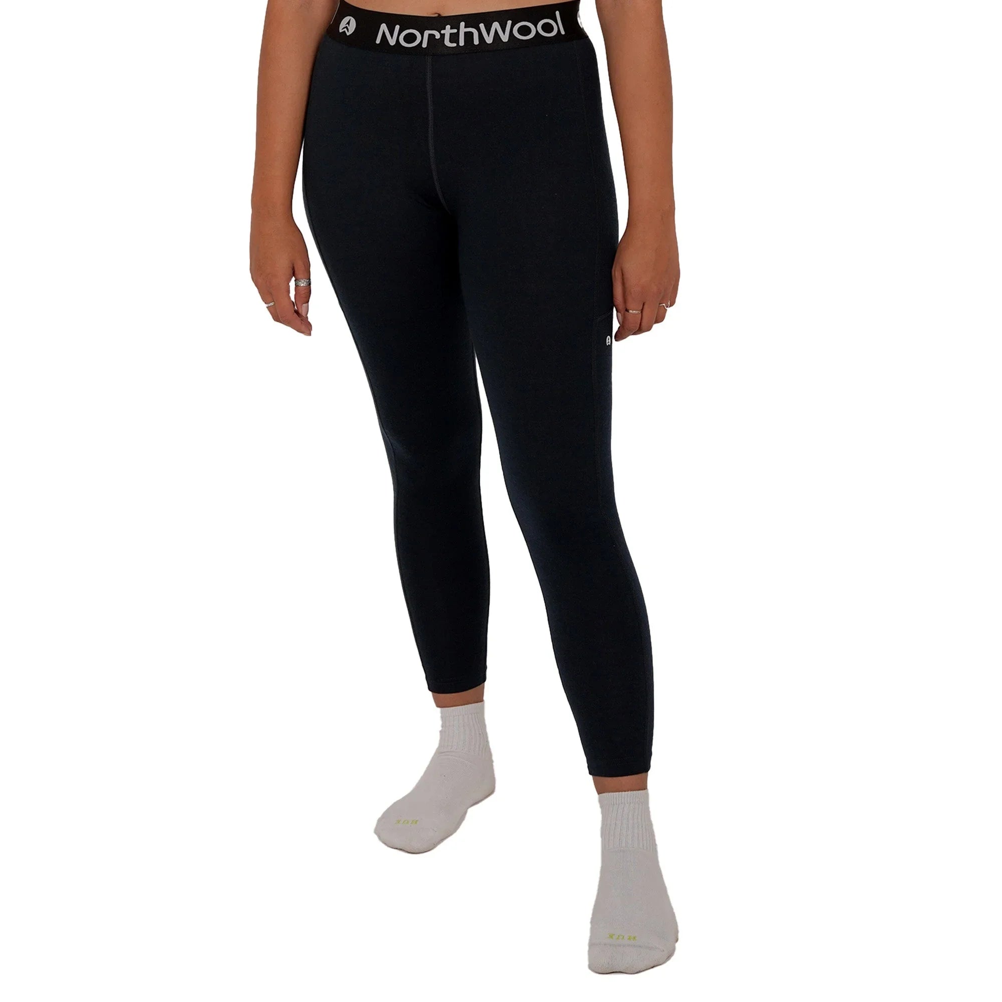 Woman wearing black NorthWool thermal leggings with branded waistband on white background