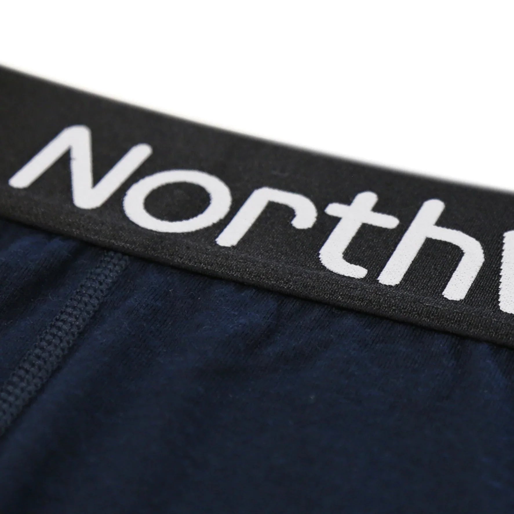 Close-up of navy blue underwear with black waistband and white North branding