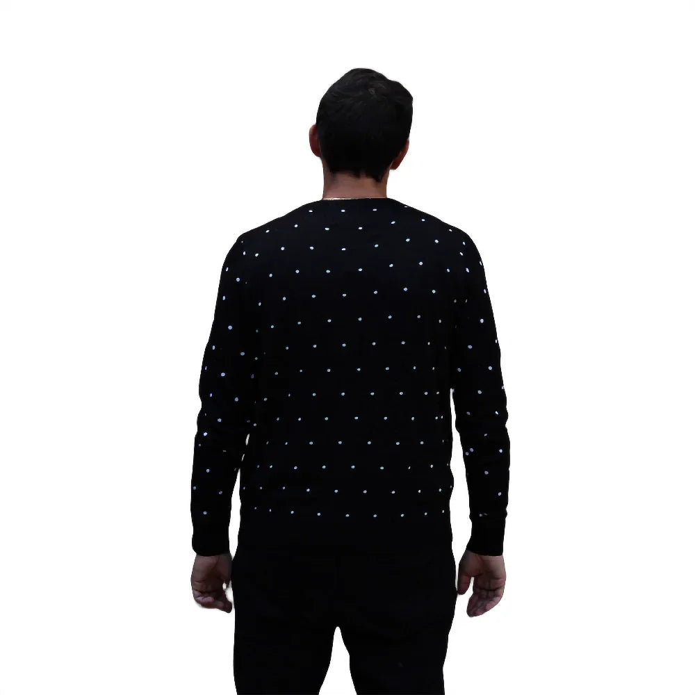 Man wearing black sweater with white polka dots, back view on white background
