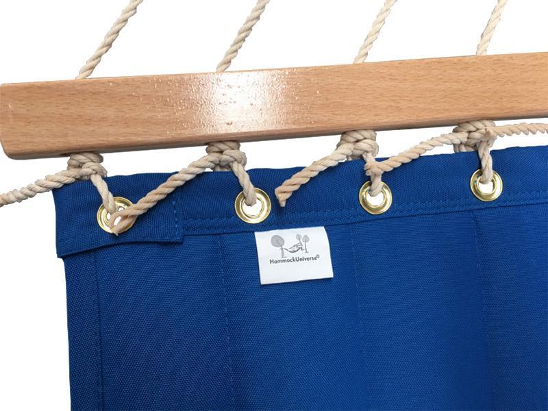 Blue olefin hammock with wooden spreader bar, brass grommets, and rope detail
