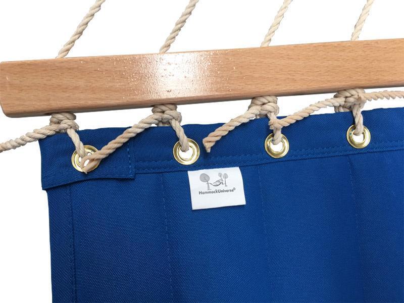 Blue olefin hammock with brass grommets, wooden spreader bar, and rope suspension