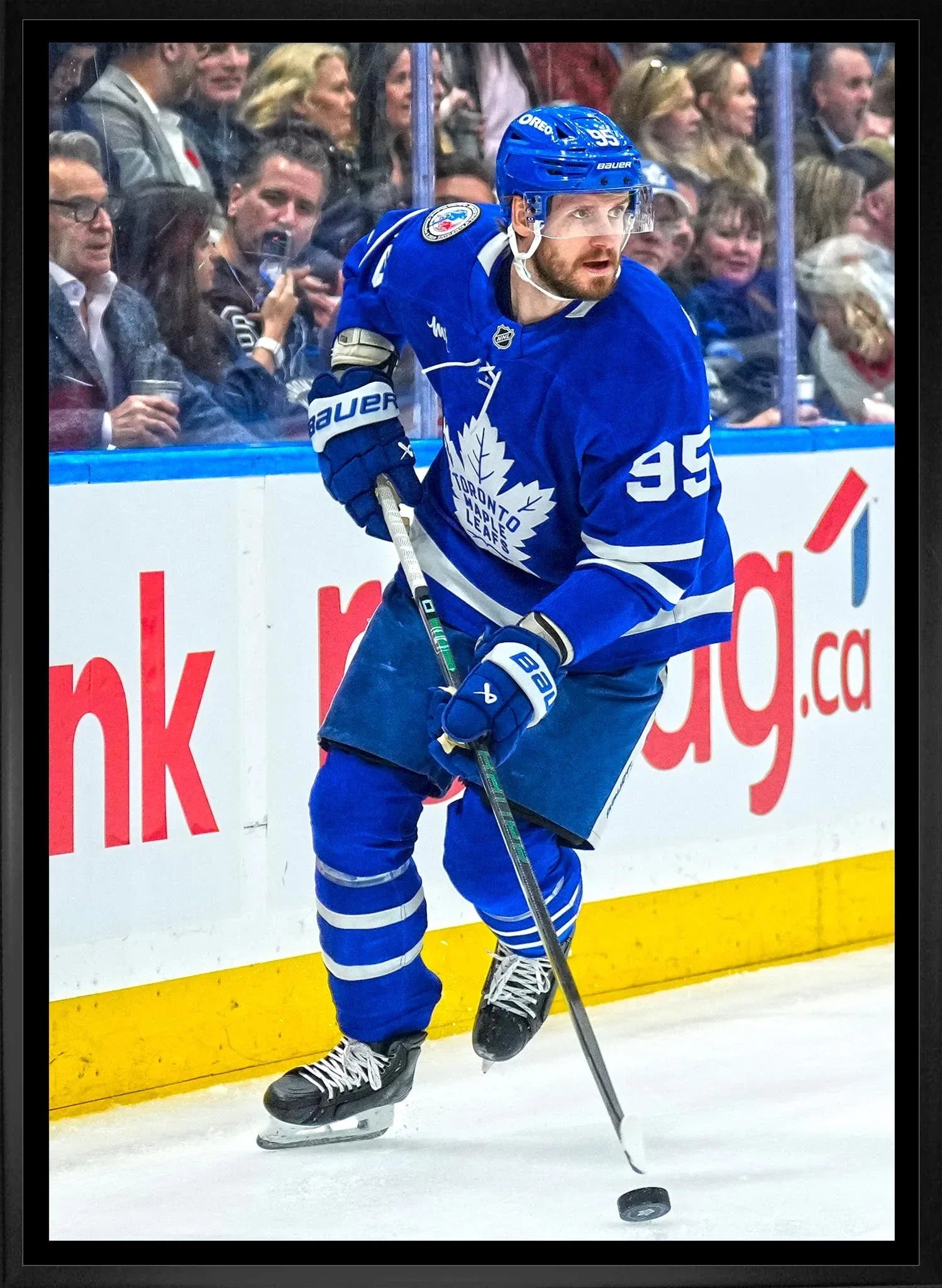 Toronto Maple Leafs hockey player in blue uniform skating on ice during game