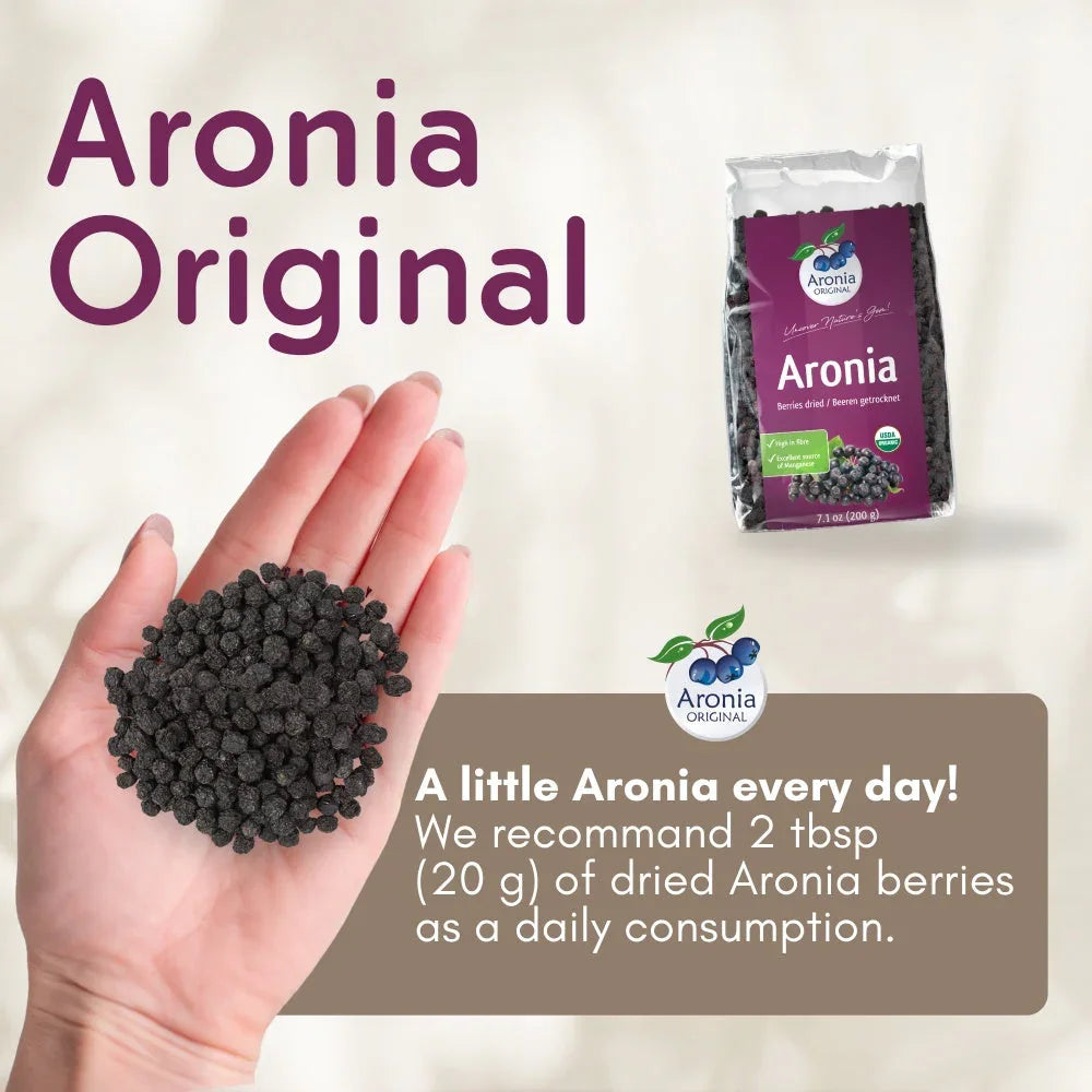 Hand holding dried Aronia berries with Aronia Original packaging and daily use recommendation.