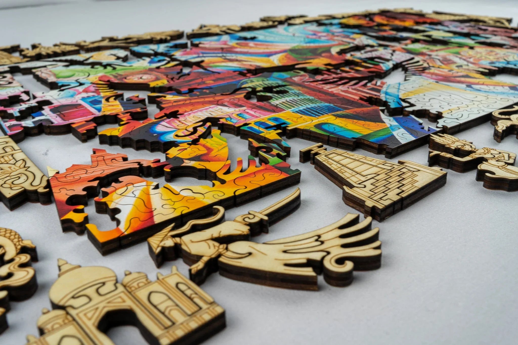 Colorful wooden puzzle pieces featuring intricate designs and famous landmarks on a table