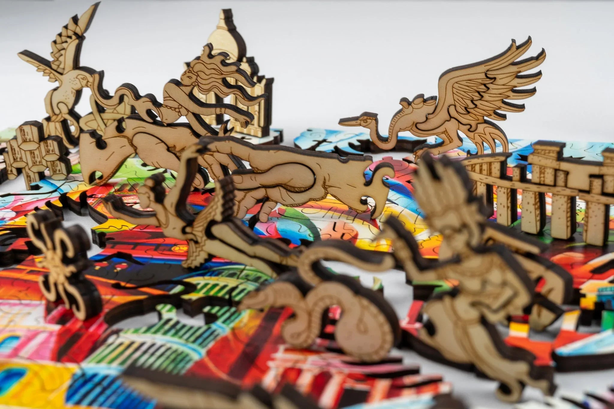 Colorful art puzzle with wooden fantasy figures and mythical creatures on top