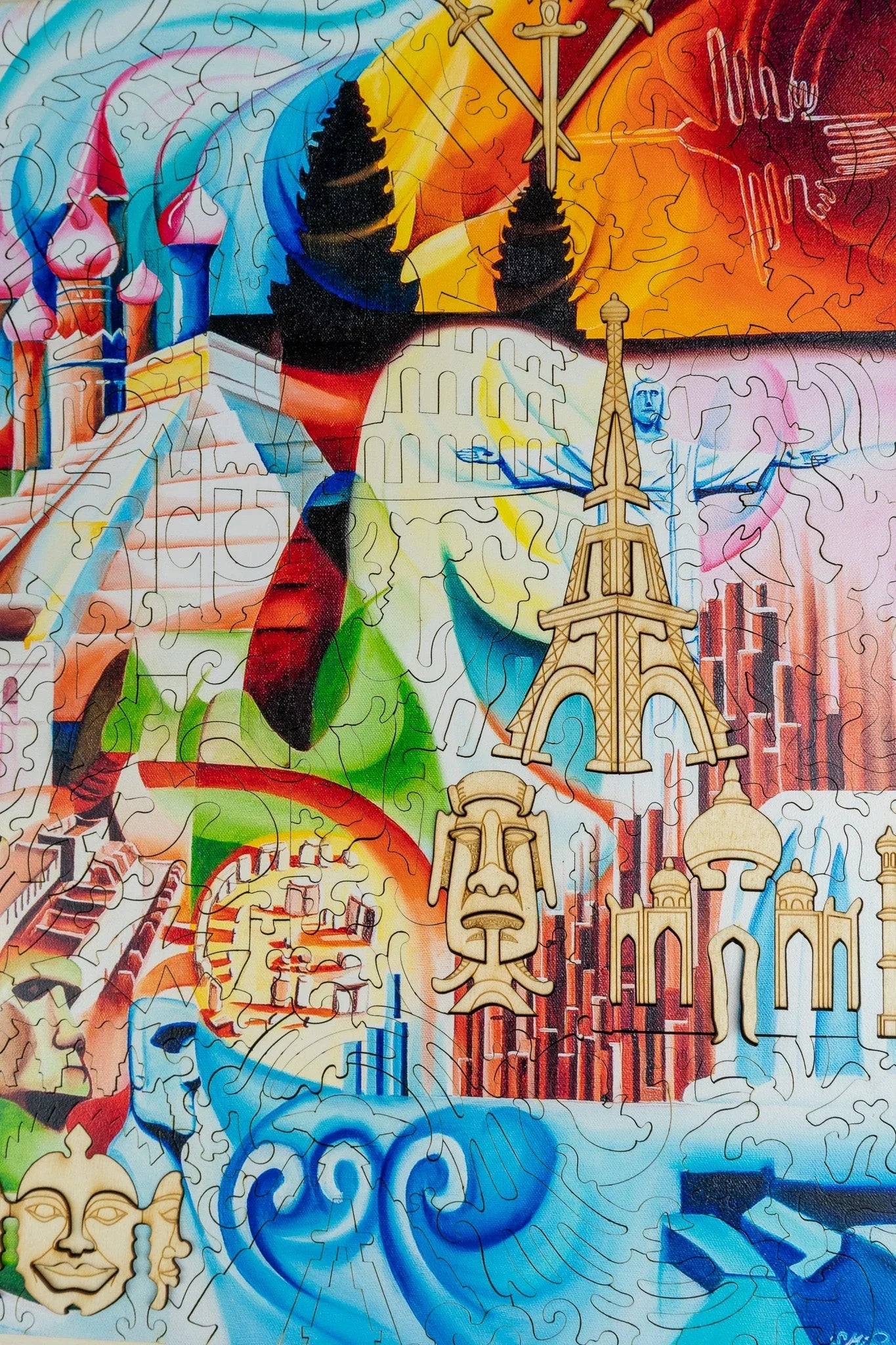 Colorful world landmarks puzzle featuring the Eiffel Tower, Taj Mahal, Christ the Redeemer, and ocean waves