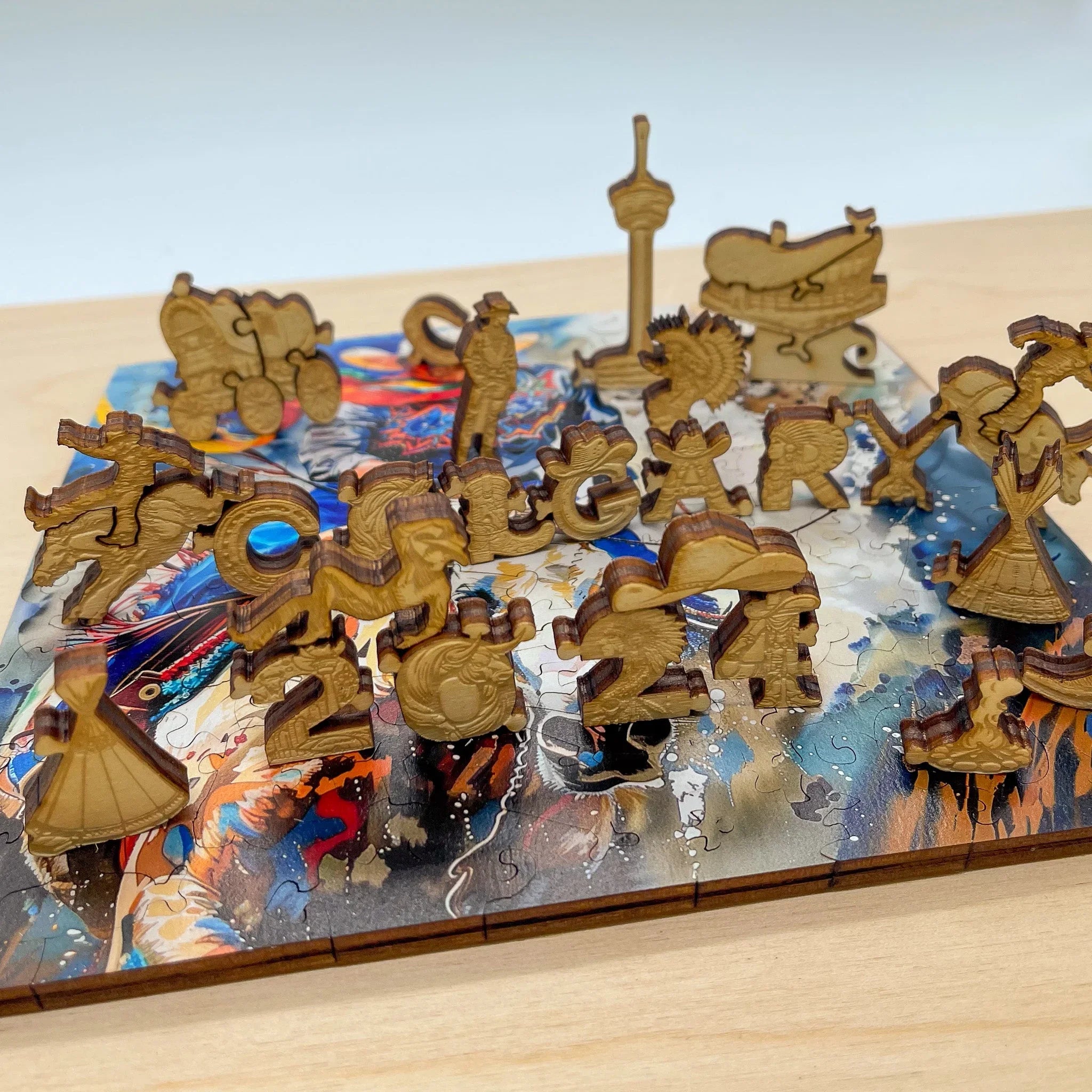Calgary-themed wooden puzzle pieces on colorful puzzle board, cowboy hat and skyline visible