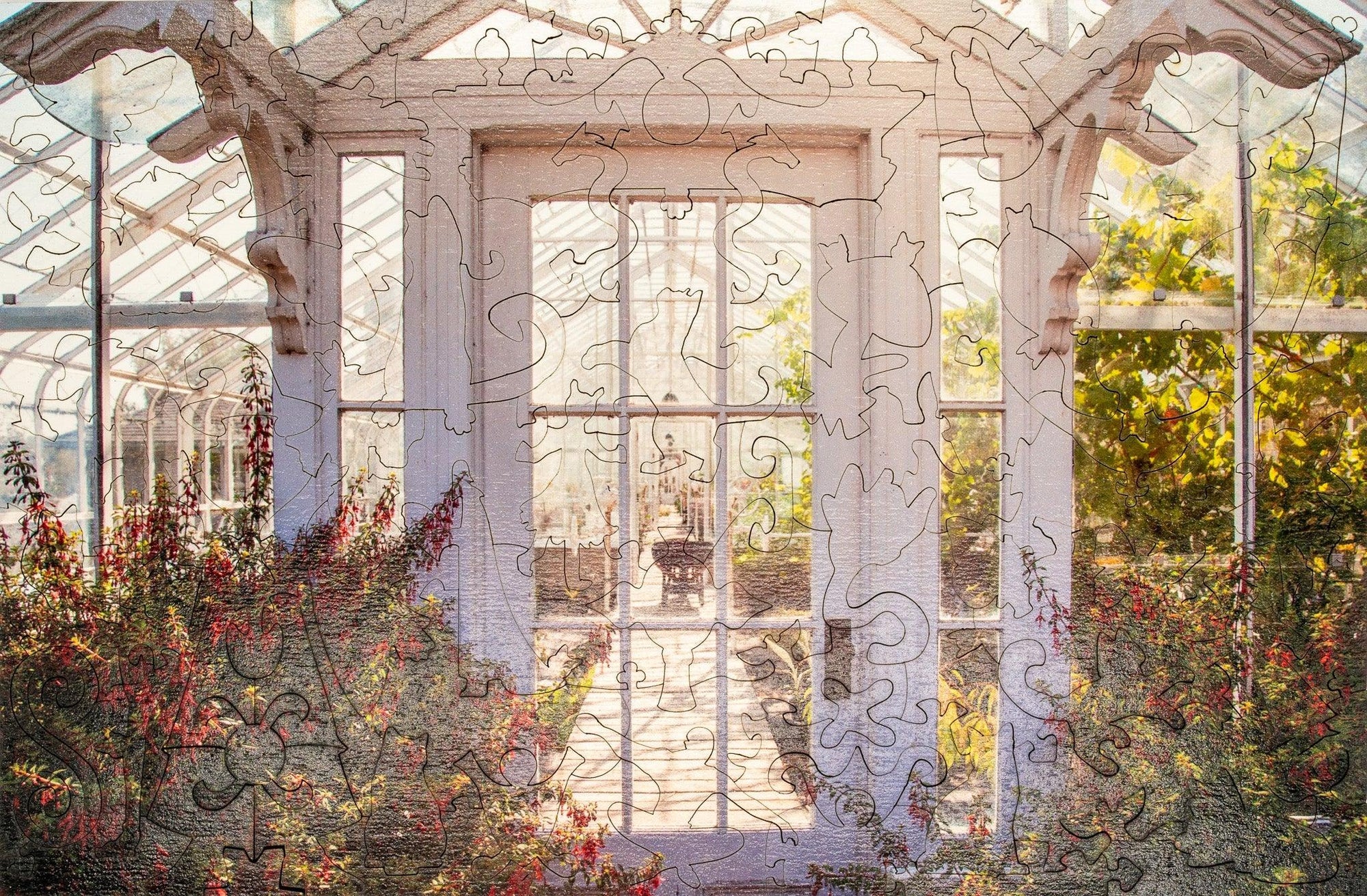 Wooden jigsaw puzzle showing a sunlit greenhouse with flowers and glass windows
