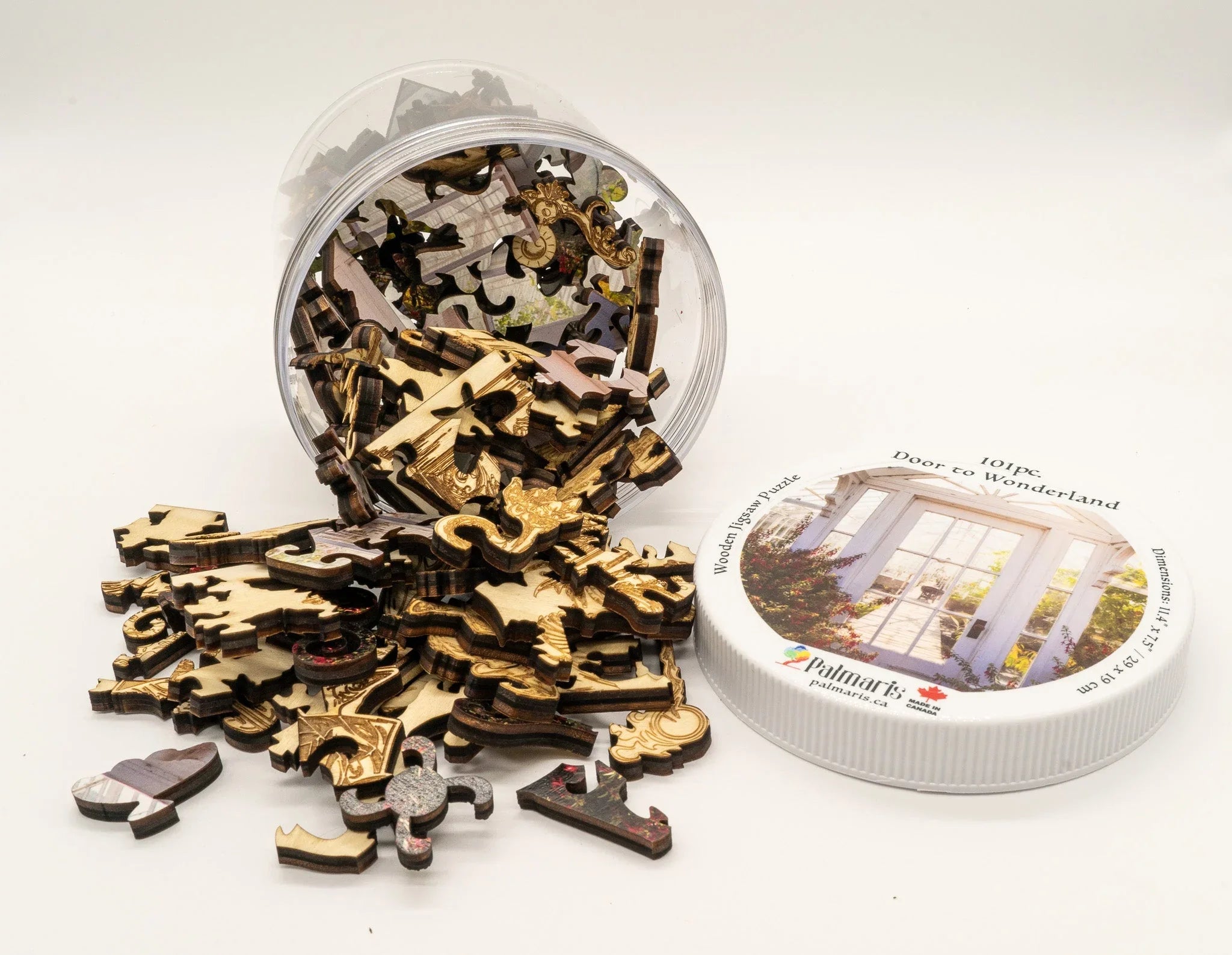 Wooden jigsaw puzzle pieces spilled from clear jar with 'Door to Wonderland' puzzle lid
