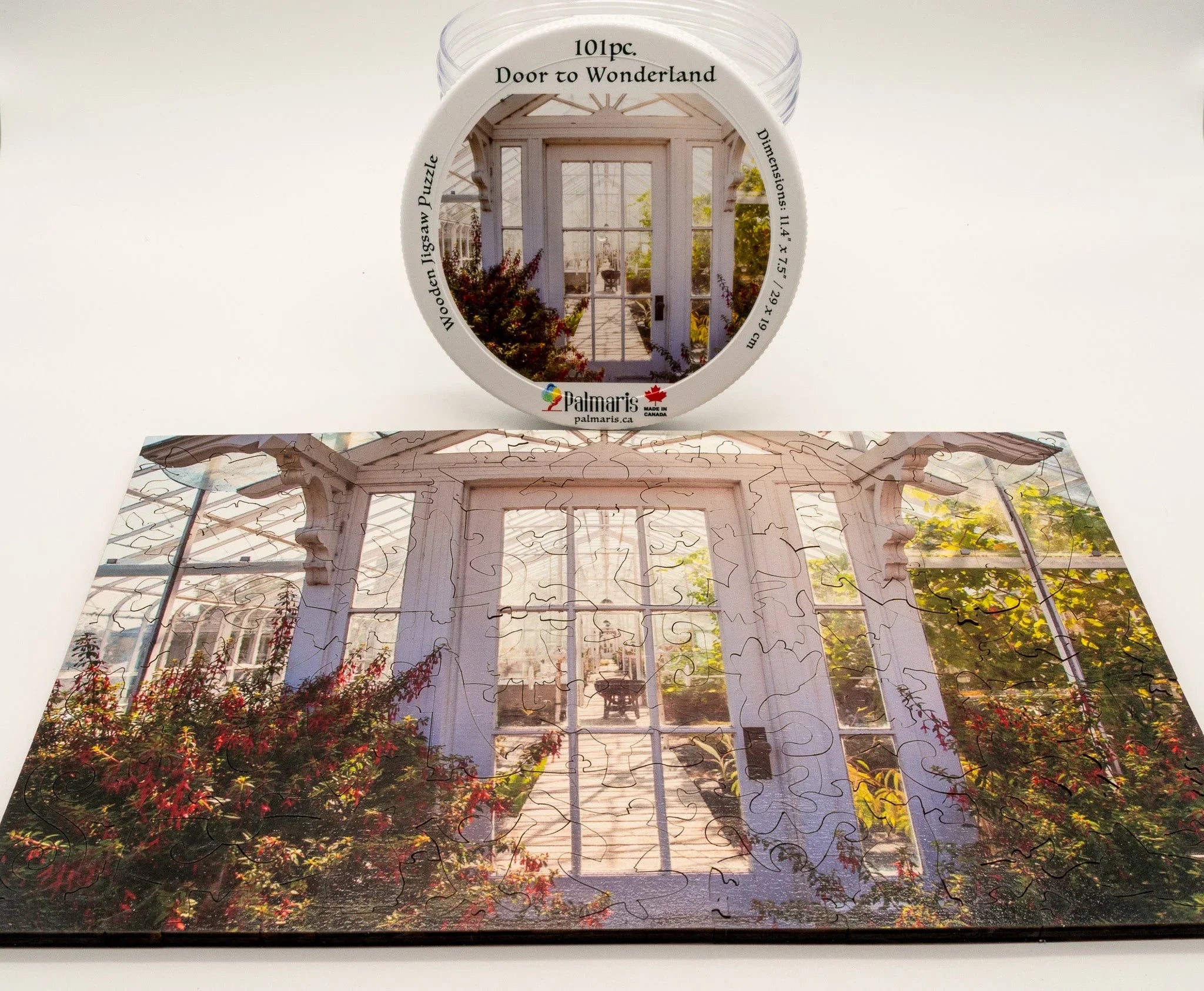 101 piece Door to Wonderland wooden jigsaw puzzle with greenhouse door image and decorative plants
