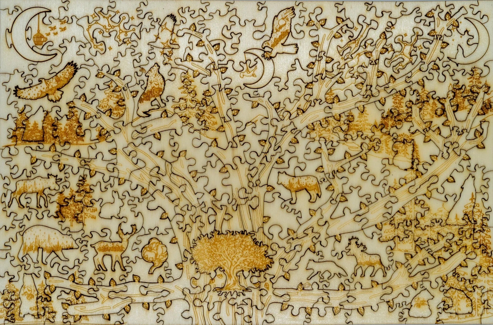Laser-cut wooden animal puzzle with forest, wolves, owls, and moon details