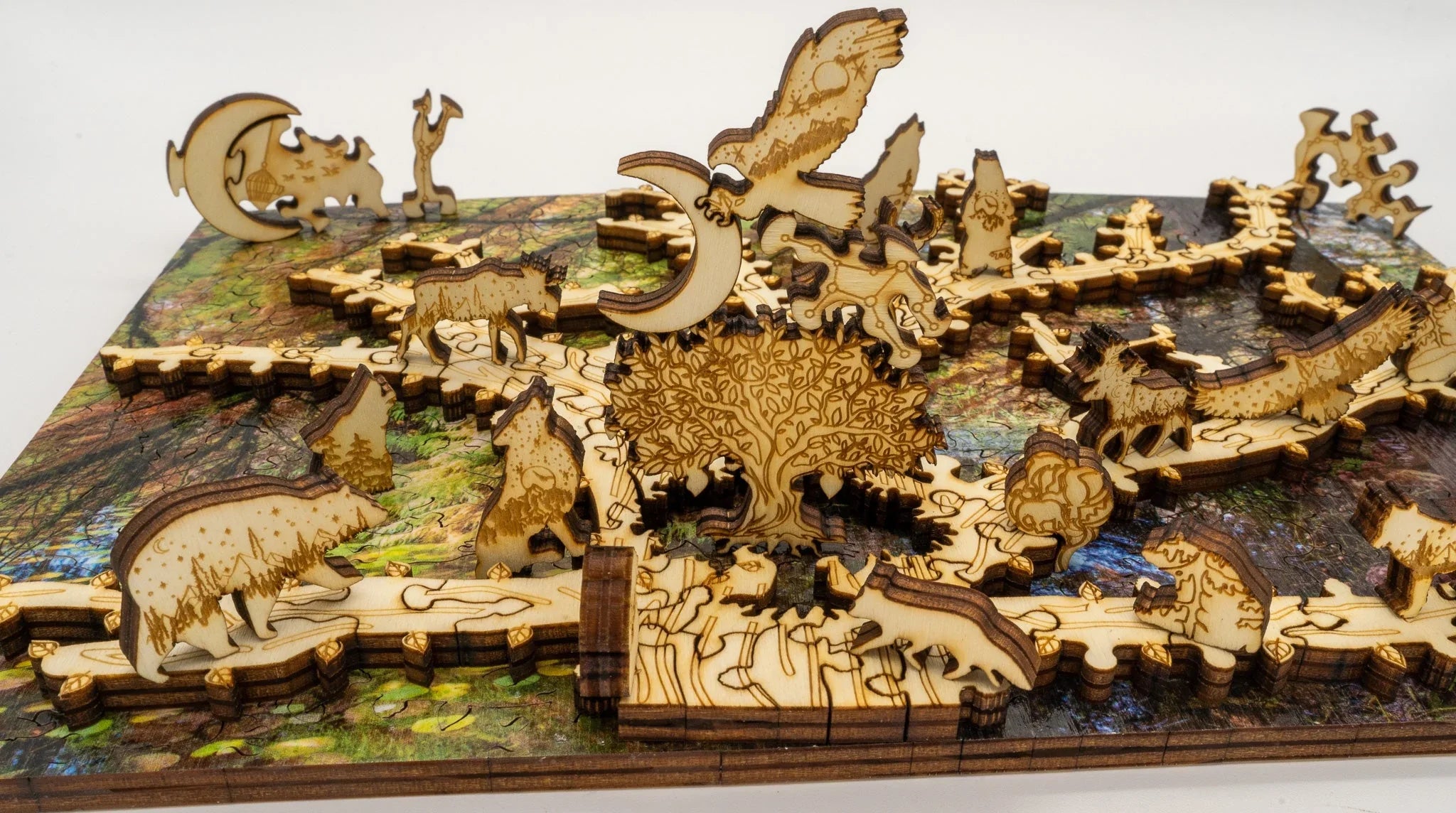 Wooden animal puzzle with engraved forest designs and 3D animal pieces on a colorful base