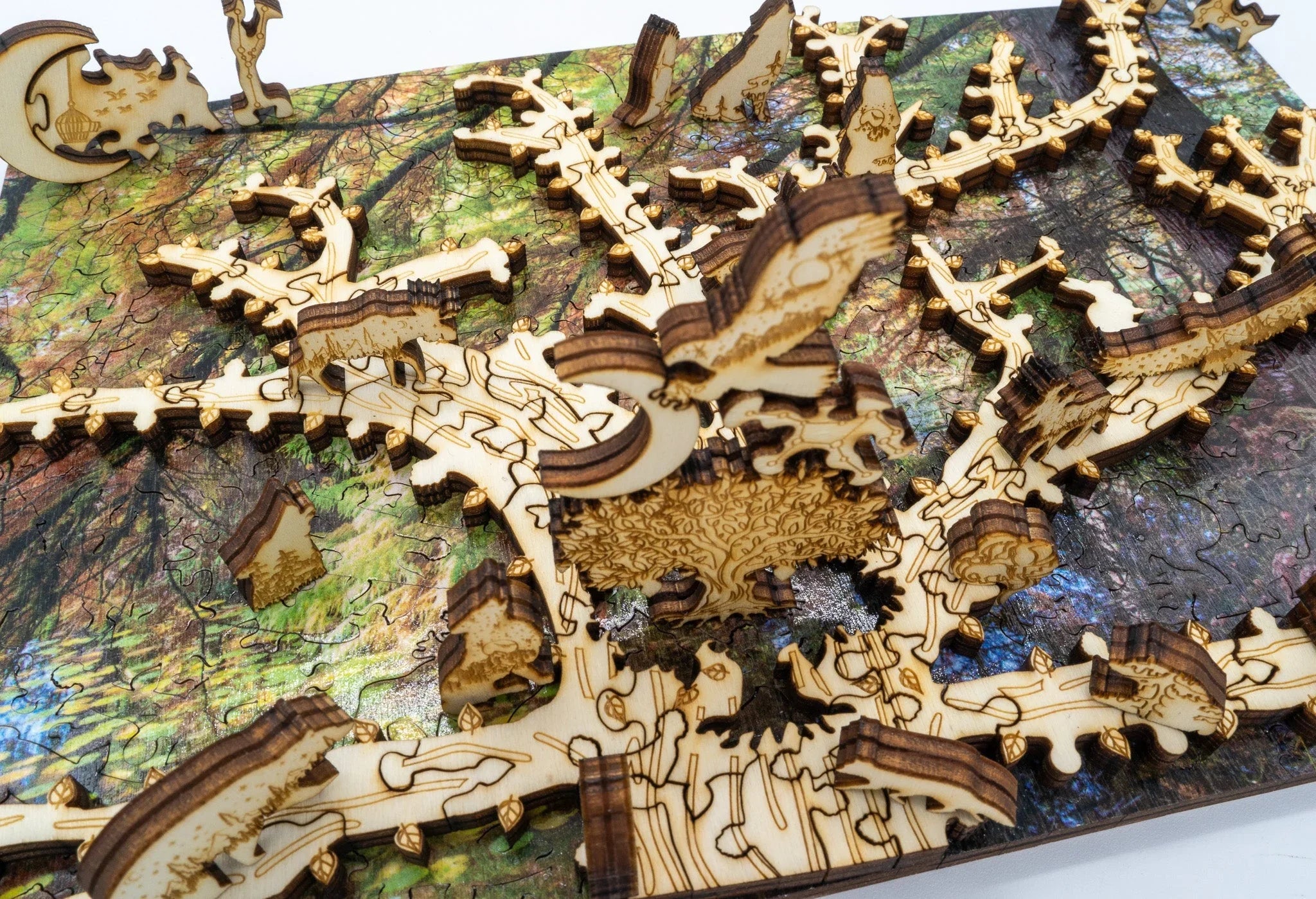 Laser-cut wooden puzzle with tree and forest design, intricate details and layered pieces