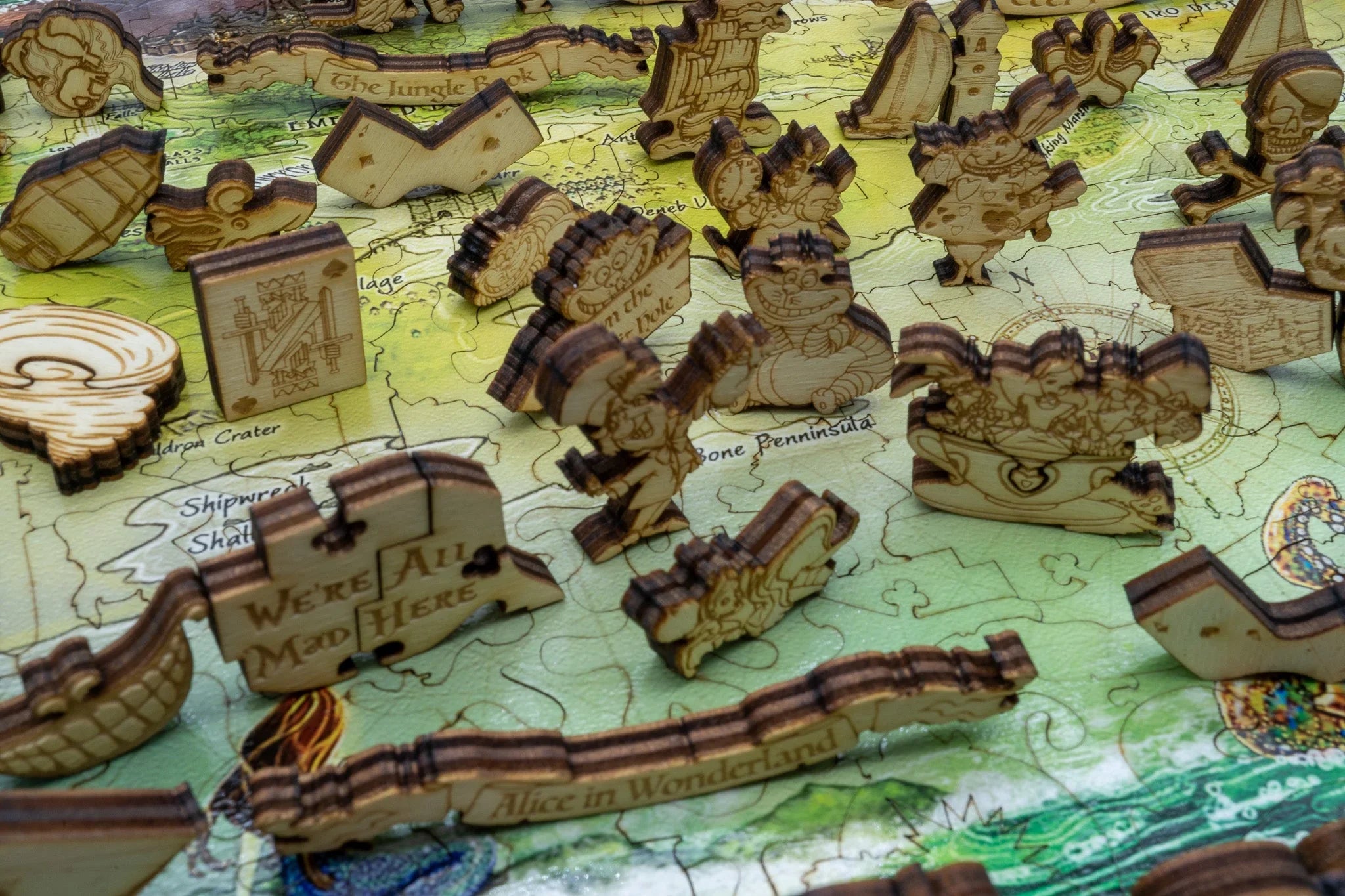 Wooden Alice in Wonderland puzzle pieces on illustrated map background