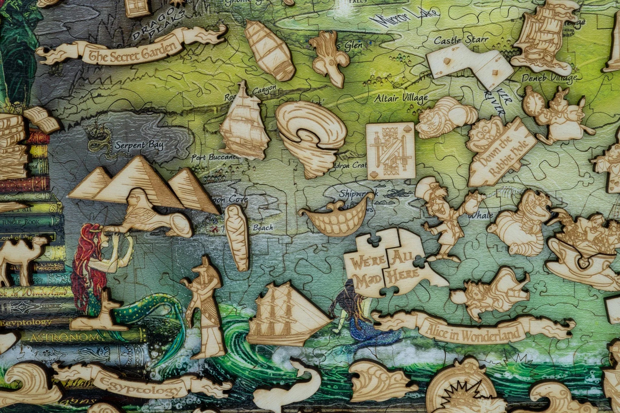 Wooden puzzle pieces of classic books and fairy tales on illustrated map
