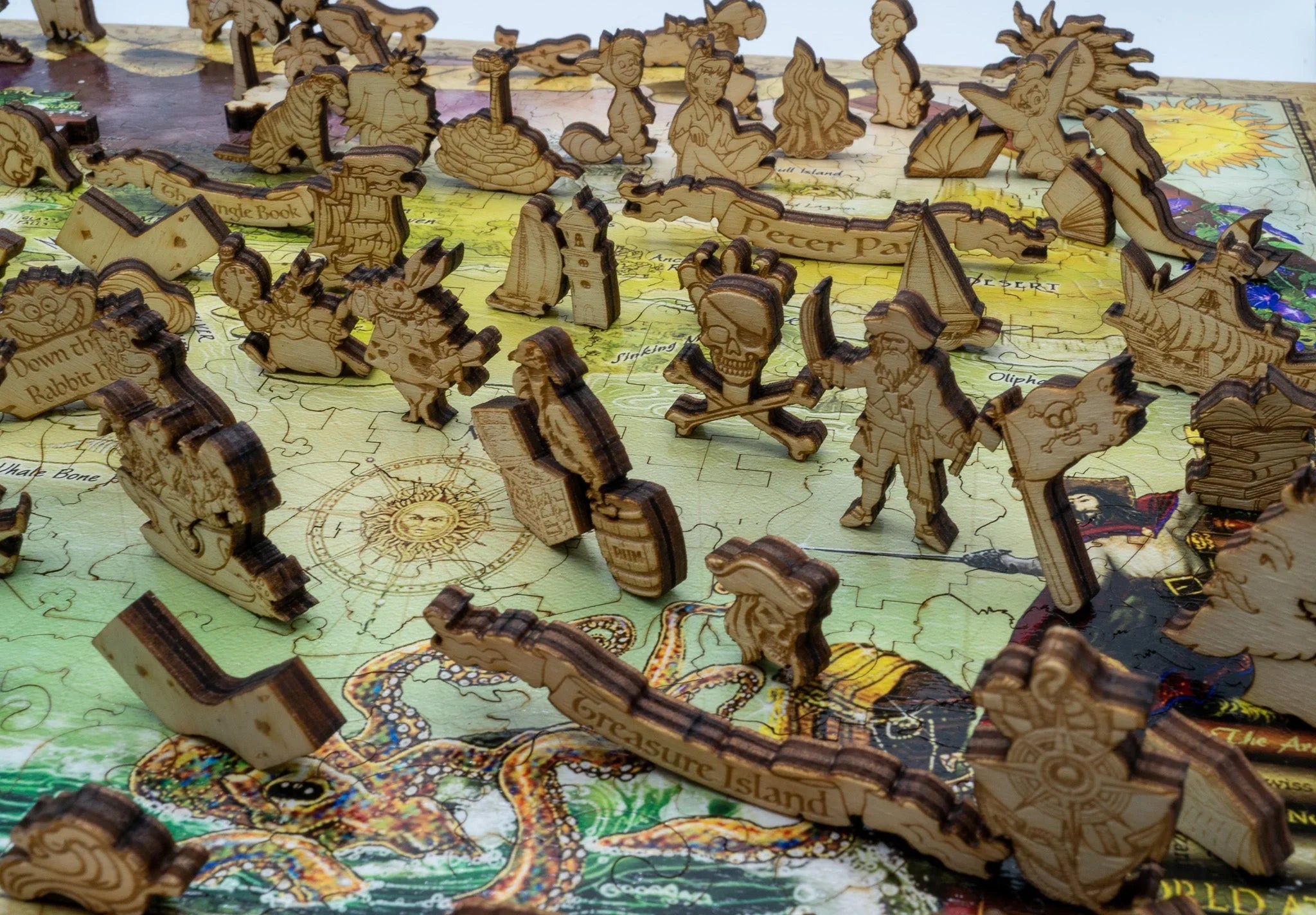 Laser-cut wooden game pieces on a colorful illustrated Treasure Island puzzle map